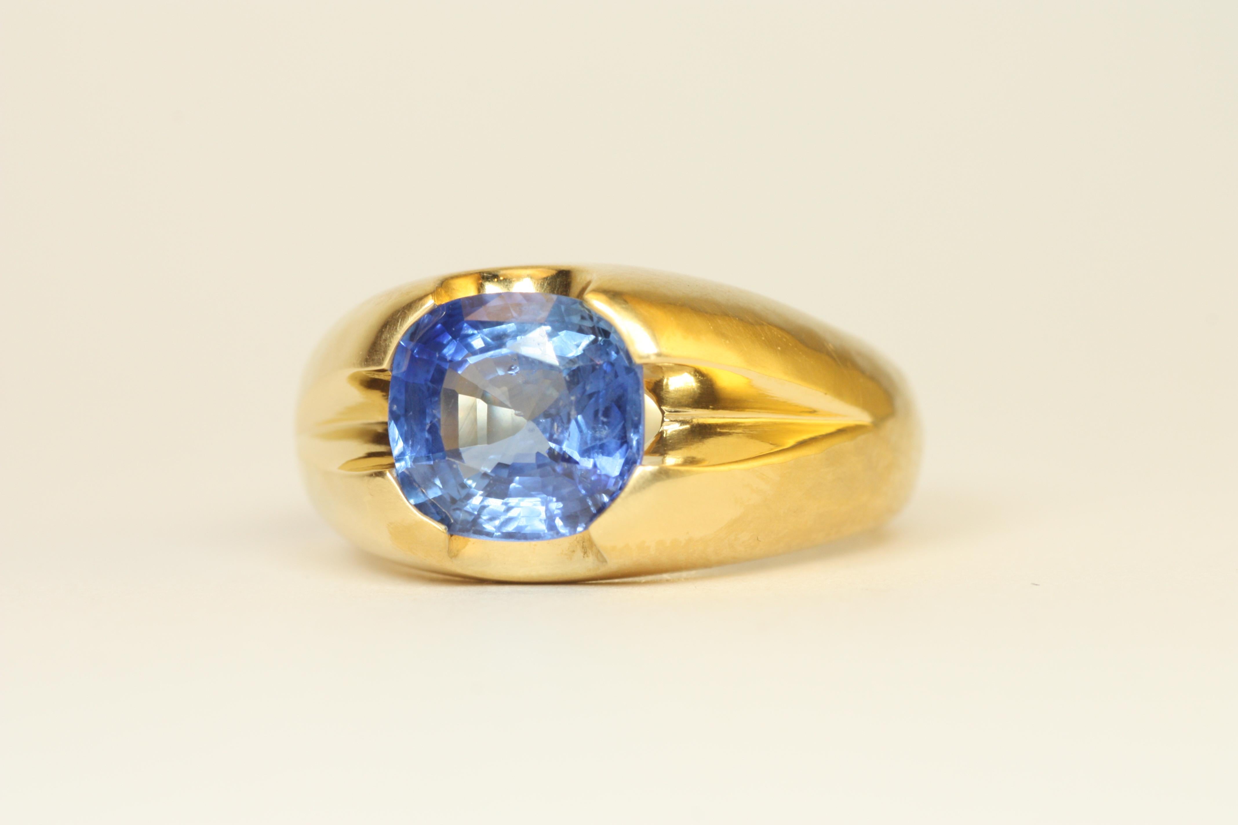 Showcasing a stunning 3.38ct oval Ceylon blue sapphire, this large split-shank ring is a masterpiece of bold elegance and craftsmanship. Made with 22K yellow gold, this ring features Bracken Jewelers' signature soft-hammered finish for a timeless