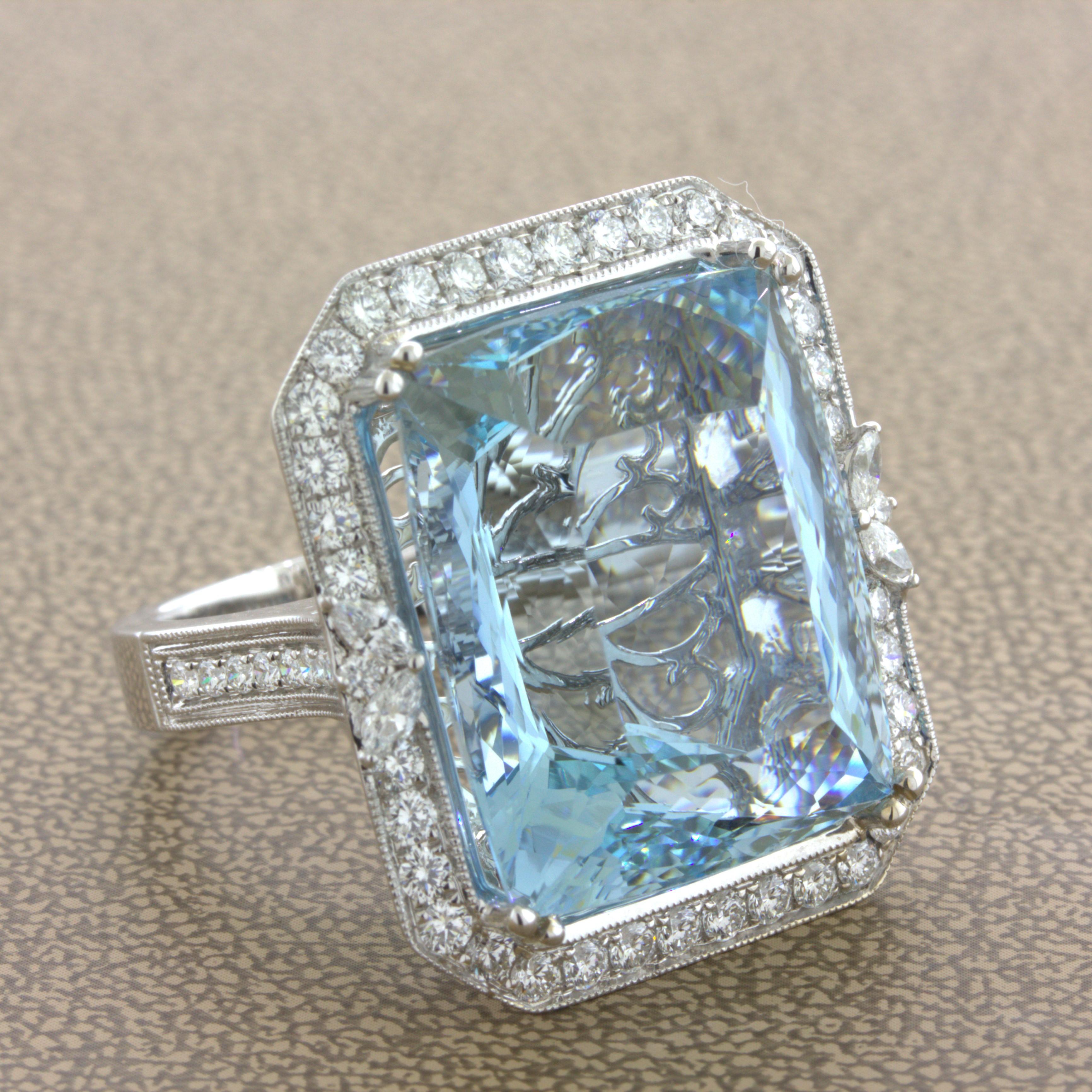 A large and stunning aquamarine diamond cocktail ring. The massive aquamarine weighs an impressive 33.68 carats and has a rich sea-blue color which aquamarine is known for. Surrounding the fine gem are 1.47 carats of bright white diamonds which add