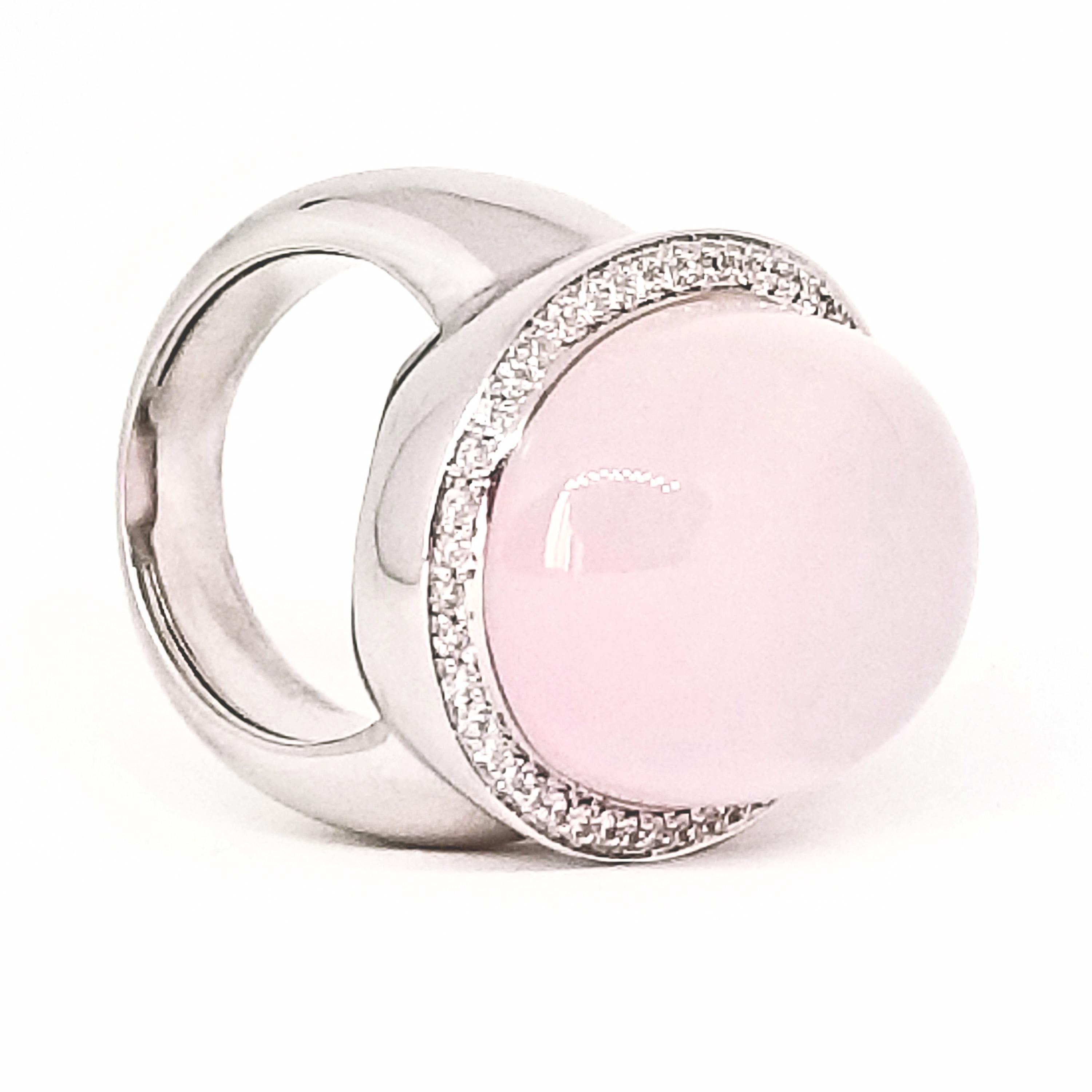 This Beautifully made, Contemporary Statement Ring features a 33.87 carat Rose Quartz Cabochon. The Oval Shaped, High Cabochon stone is a Semi Translucent Pink with the Glowing characteristics of a Moon Stone. The Stone is exceptionally clean and is