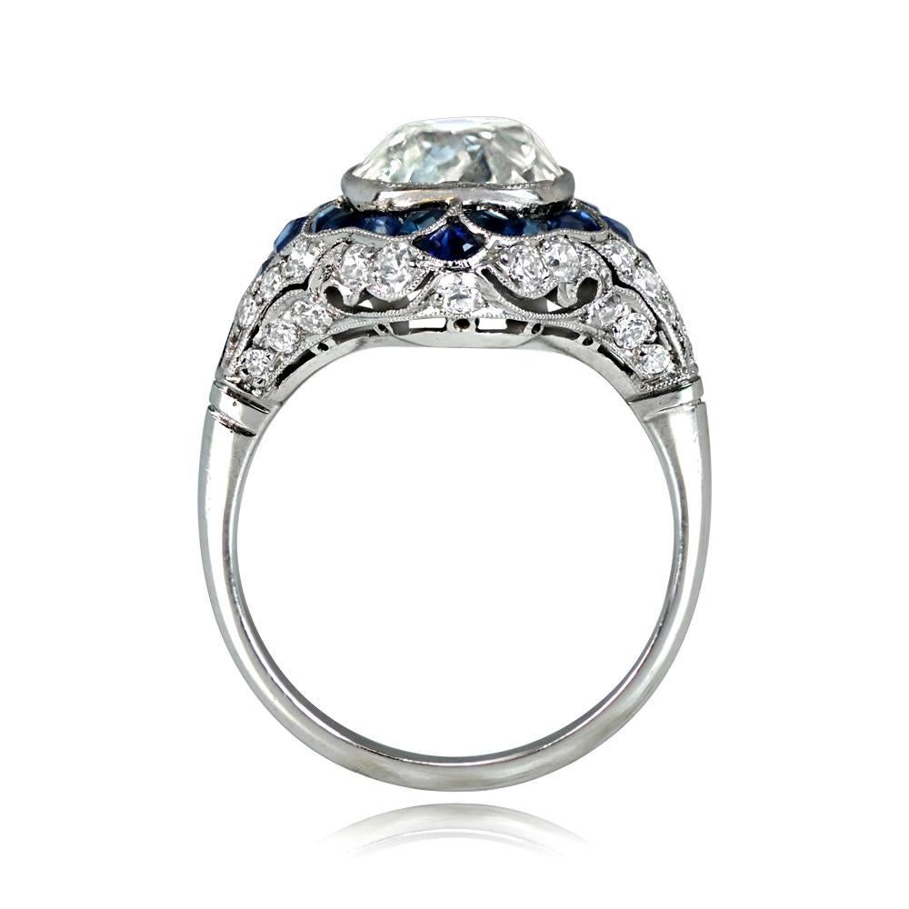 Art Deco-inspired platinum ring with a 3.38-carat antique cushion cut diamond, L color and SI1 clarity. The center stone is complemented by a floral design of calibre natural sapphires and old European cut diamonds, which extends along the