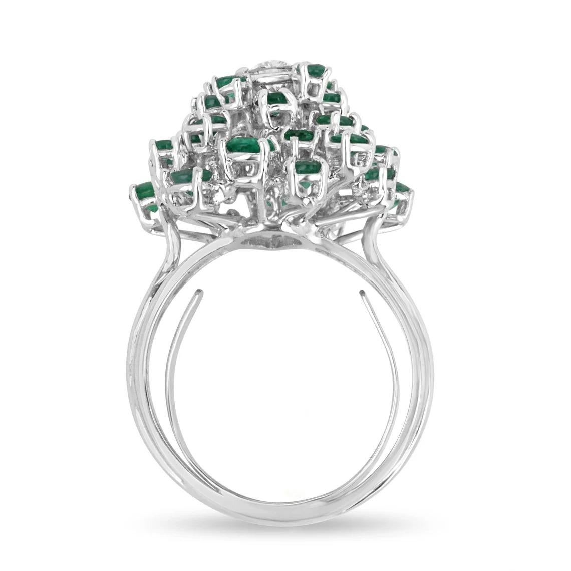 A pear cut diamond & Colombian Emerald cluster statement ring in 14K white ring. A VVS1 quality diamond is set in the midst of an emerald sea. Offering full finger coverage, this ring showcases exquisite gemstones in a one-of-a-kind