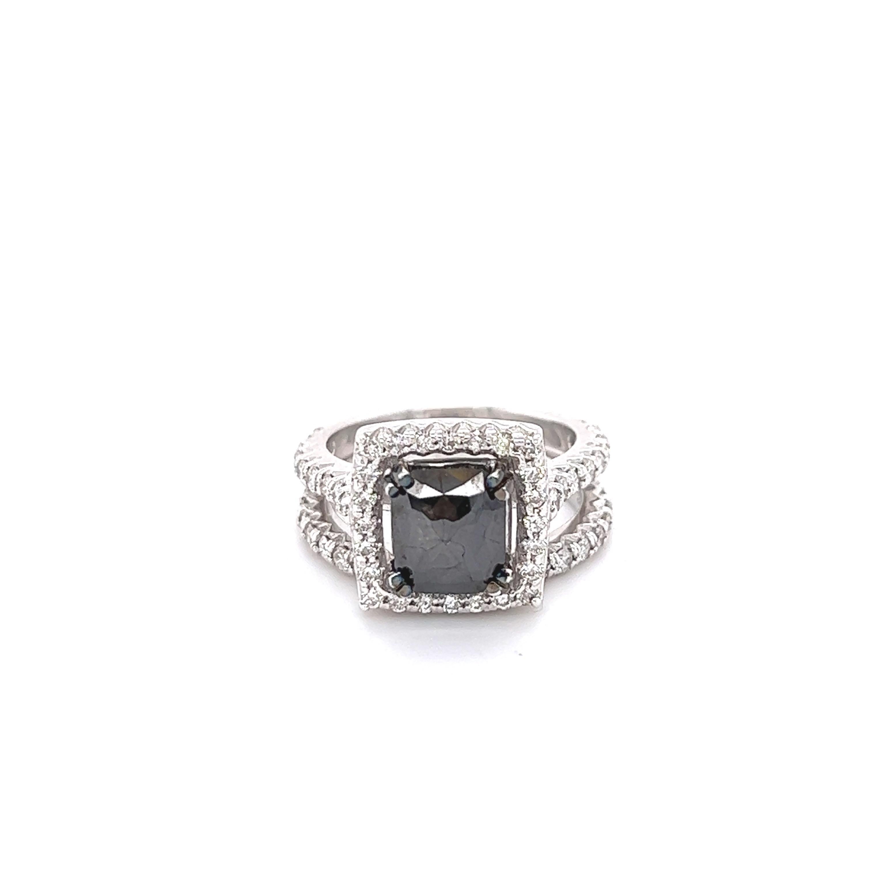 The Natural Cushion Cut Black Diamond is 2.34 Carats and is surrounded by 56 Round Cut Diamonds weighing 1.05 Carats (Clarity: VS, Color: H) The total carat weight of the ring is 3.39 Carats. The Black Diamond measures at approximately 9 mm x 7 mm.