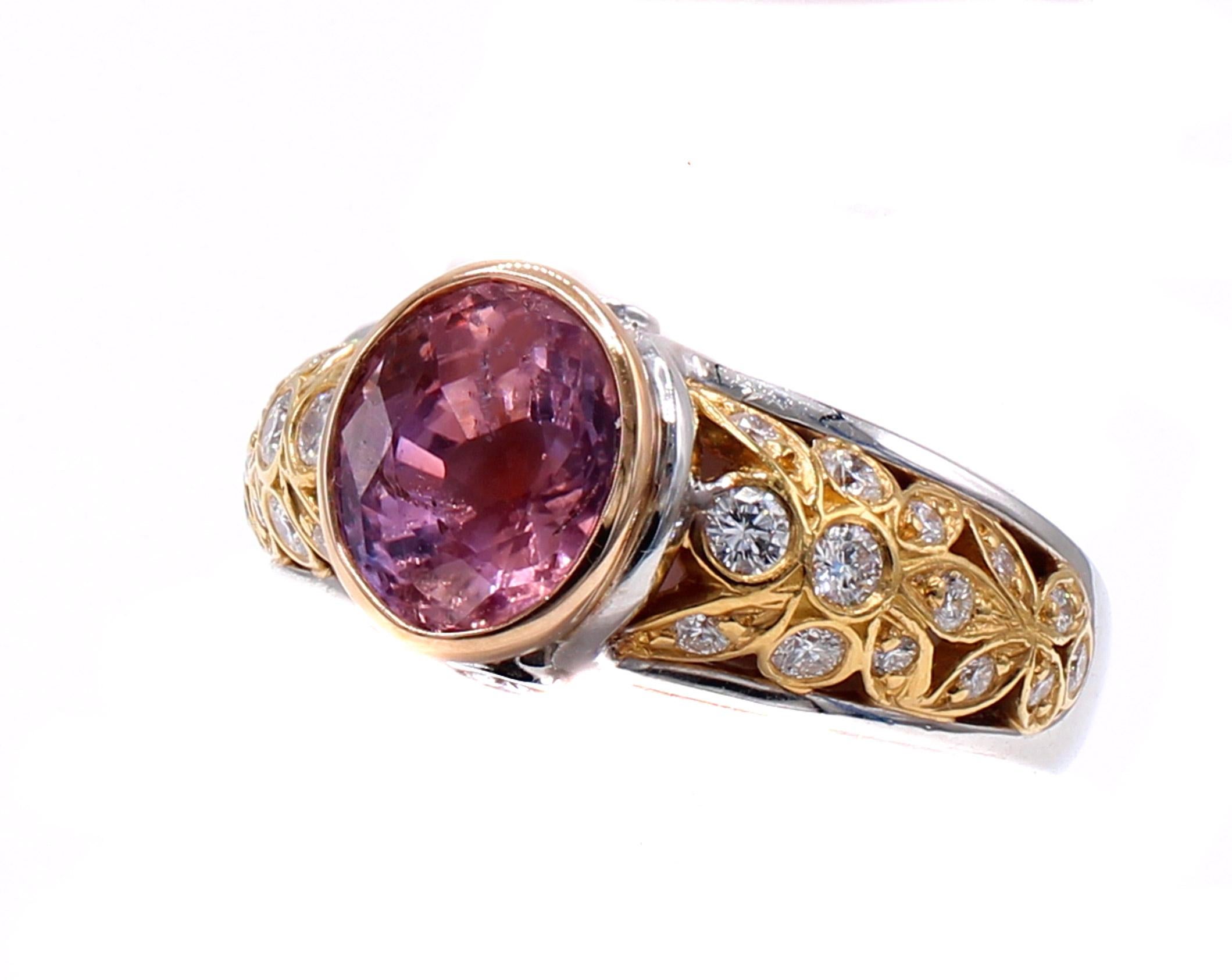 This unique, beautifully designed and masterfully handcrafted ring features an amazing and rare 3.39 carat natural Padparadscha sapphire. Showing off a gorgeous orangy pink color and set in a 22 karat rose gold bezel this beautiful gem stone is
