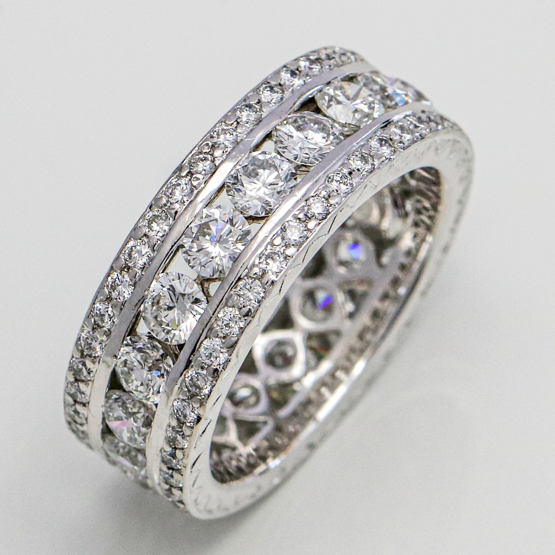 Three row diamond eternity band in platinum. The ring has a row of bezel set diamonds, and two rows of smaller prong set diamonds. 

Size, 5.25
Width, 8 mm
Total Carat Weight, 3.39 carats
Diamond Color and Clarity, VS, G-H
Weight, 9 grams 