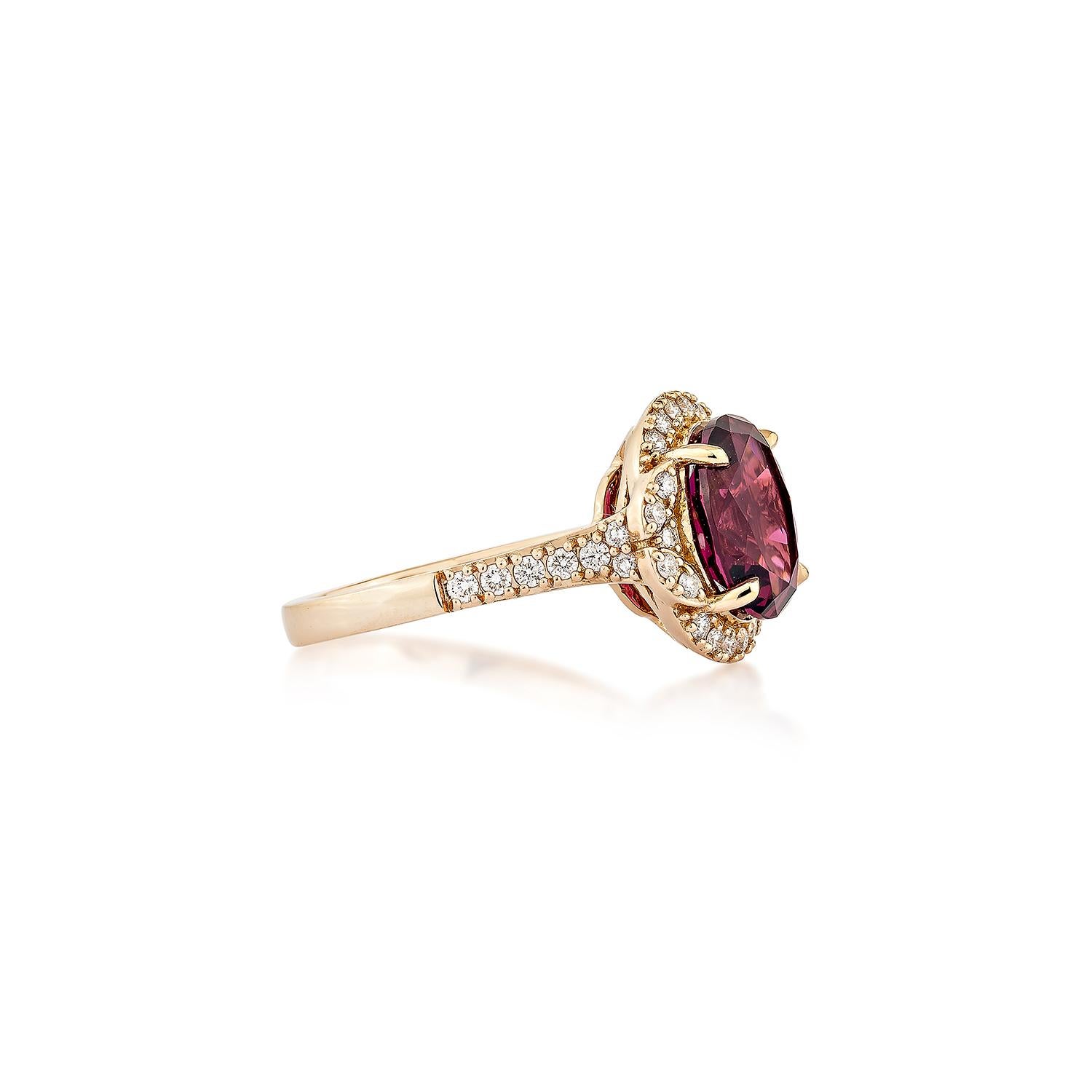 Sunita Nahata presents an elegant Rhodolite fancy ring in an oval shape, set with sparkling white diamonds. This exquisite piece exudes grace and elegance, making it perfect for both daily wear and special occasions. Crafted from 18-karat rose gold,