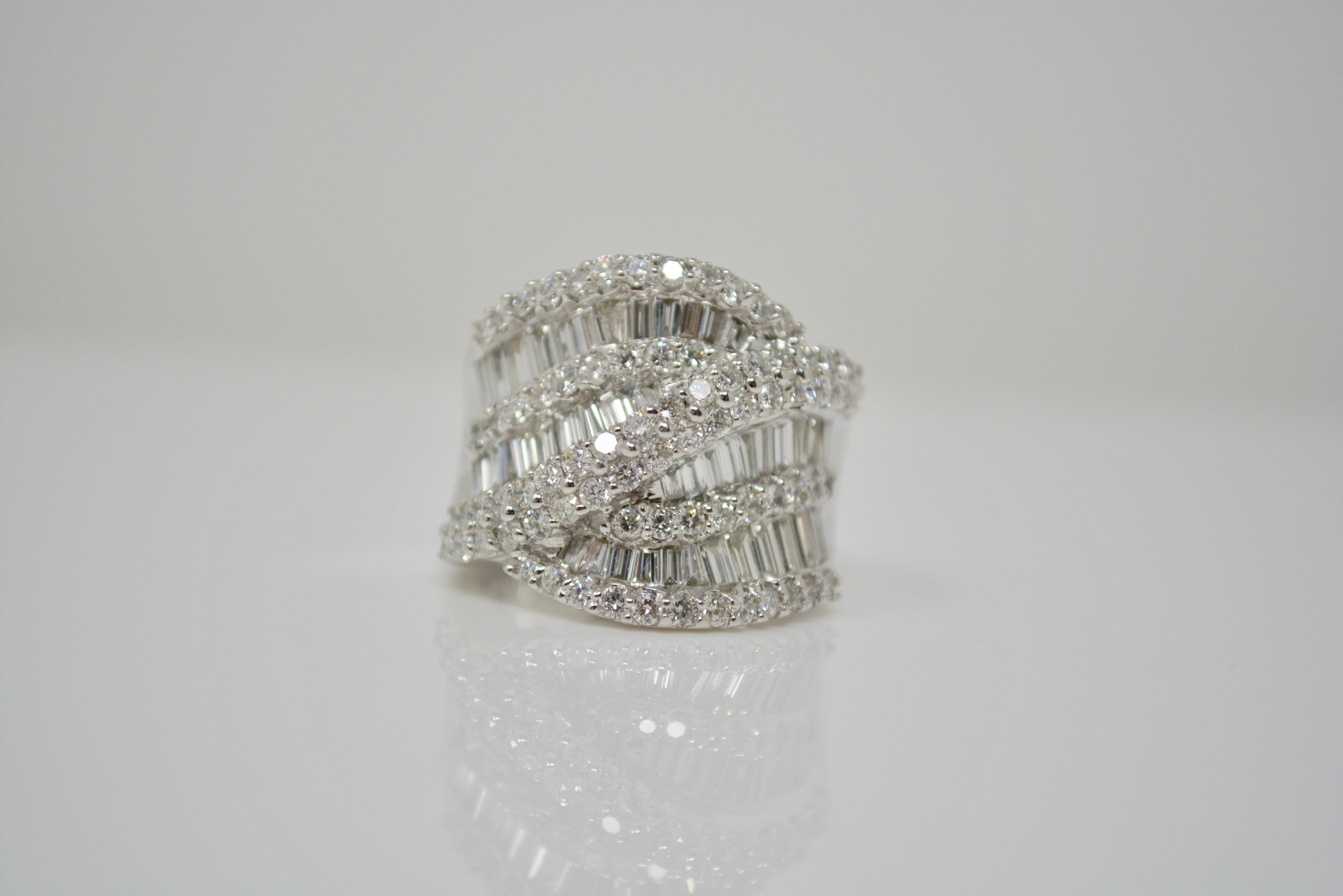 This huge and attractive cocktail ring is going to elevate your jewelry collection! This beautiful ring displays unbelievable spark. It is created be hand in 18 k white gold and features 3.39 carat of white round brilliant and baguette diamonds with