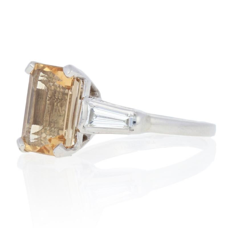 This ring is a size 4 1/4.

Metal Content: Guaranteed Platinum as stamped

Stone Information: 
Genuine Precious Topaz
Treatment: Not Enhanced   
Cut: Rectangle
Size: 9.3mm x 7mm 
Carat: 2.99ct (weighed) 

Natural Diamonds  
Clarity: VS1
Color: H 