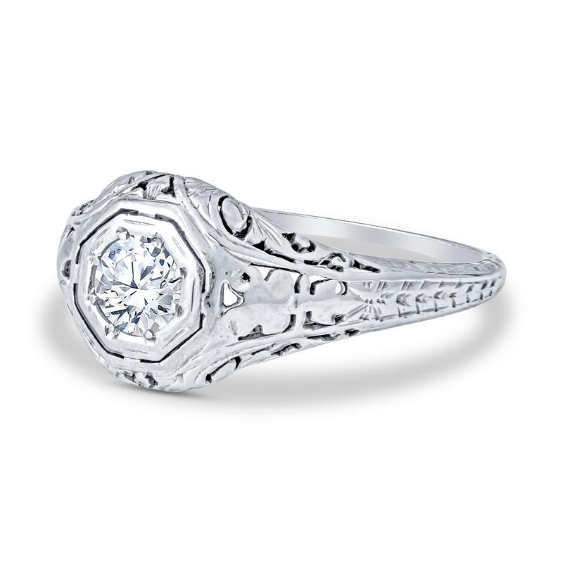 Crafted from 18 karat white gold, this vintage engagement ring features .33 carat old European cut round diamond and intricate design detailing. It is currently a size 6 but can be resized upon request.
Condition: Excellent. Previously owned but no