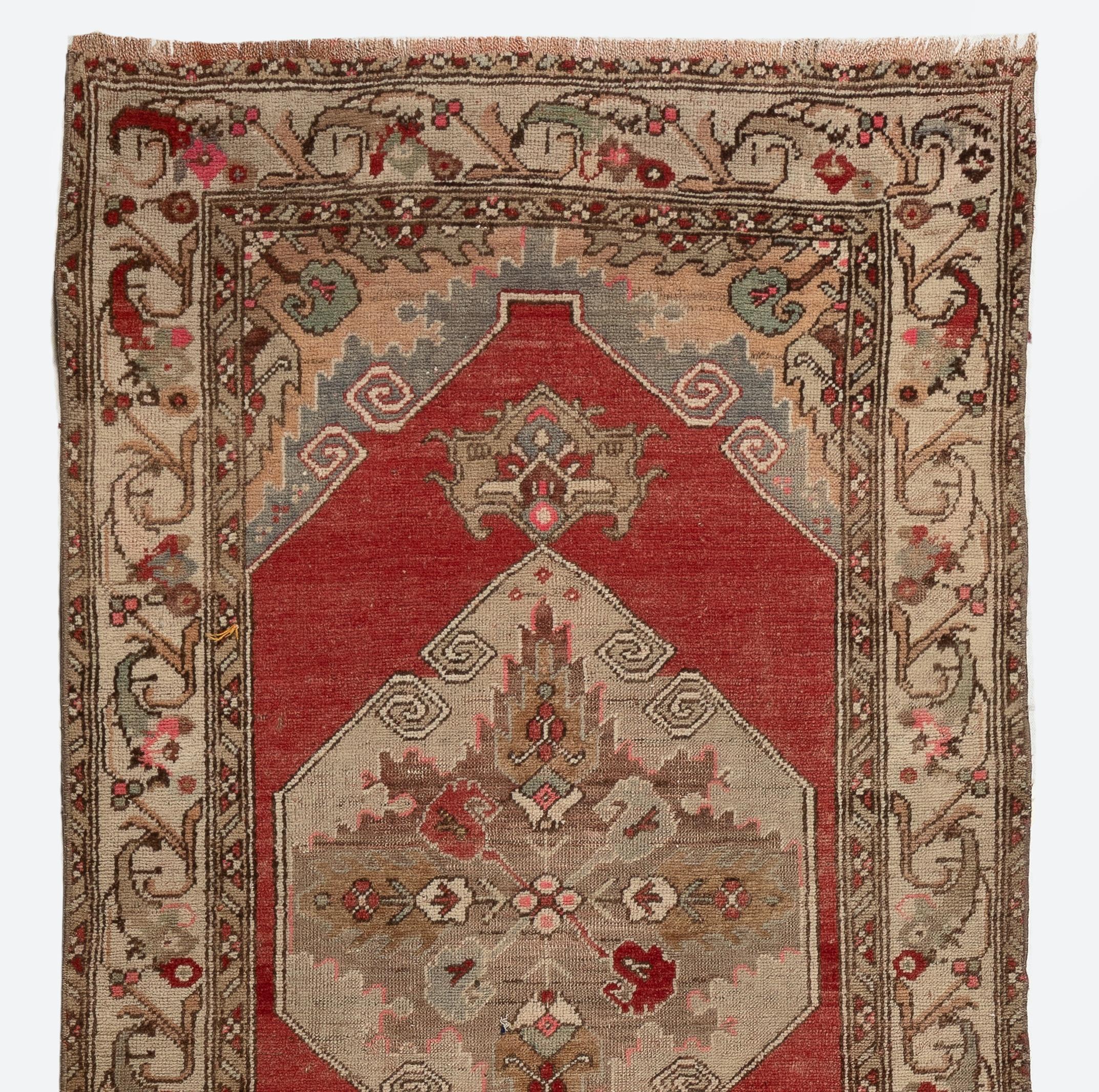 An antique hand-knotted Turkish Oushak runner rug made in the 1920s with medium wool pile. It features multiple linked geometric medallions in a lovely nuanced color palette of taupe gray and stone beige against a vermilion red background as well as