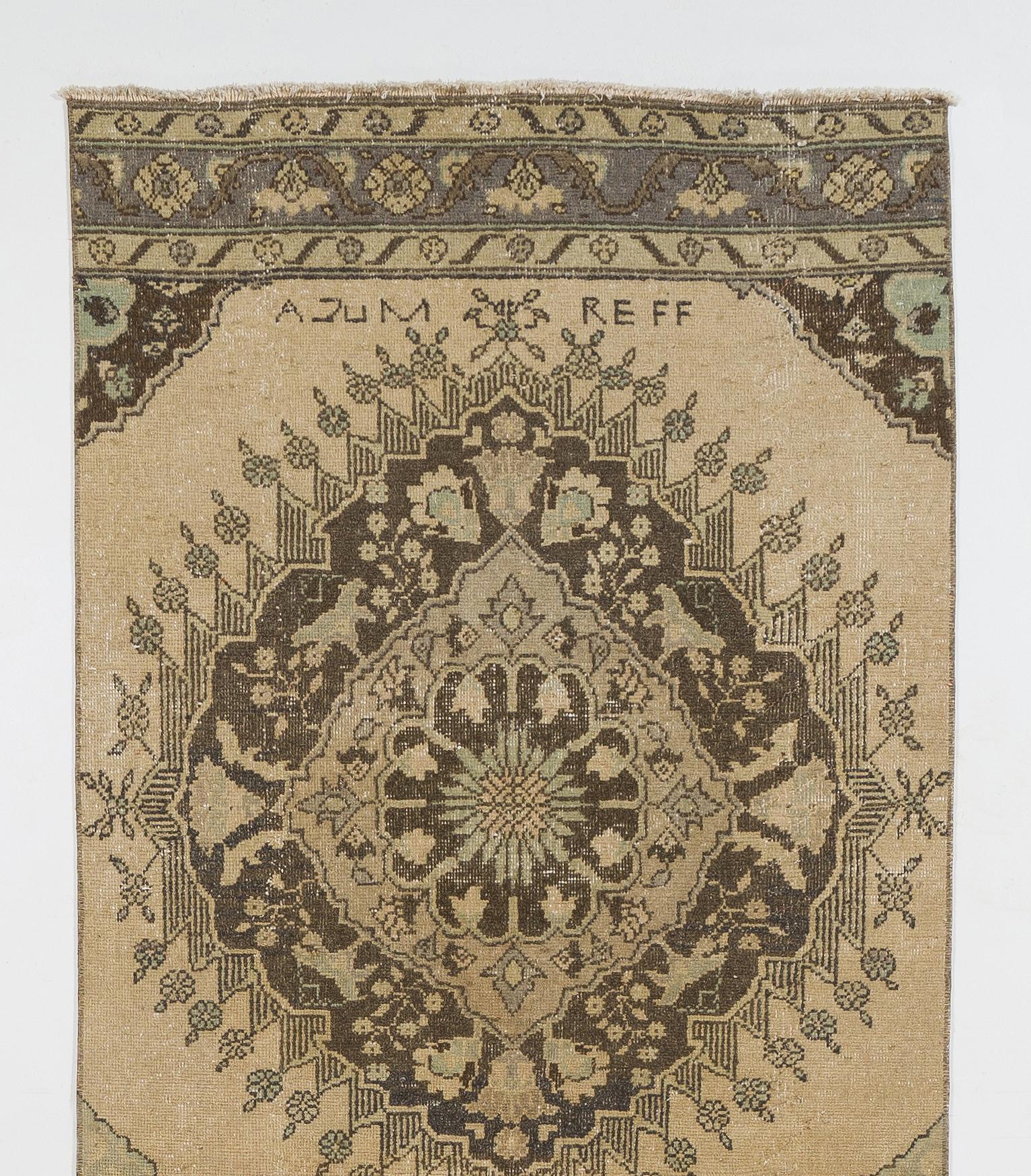 A vintage Turkish runner rug in shades of beige, brown and green colors featuring a well-drawn multiple linked medallions design. 

The rug was hand-knotted in the 1950s and has low wool on cotton foundation. It is in very good condition,