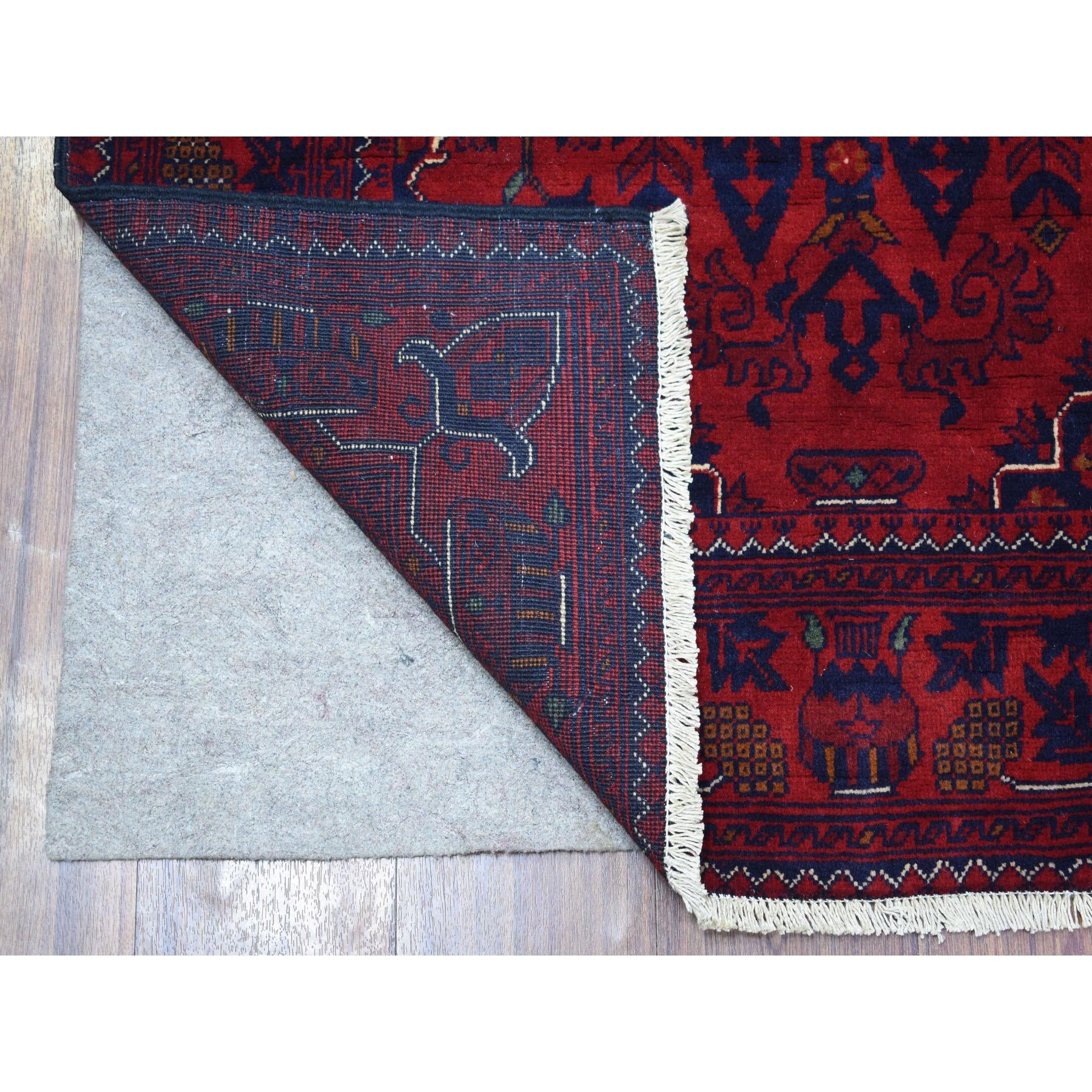 This is a truly genuine one-of-a-kind Afghan Khamyab Vibrant Wool  Hand Knotted Deep and Saturated Red Geometric Medallion Design Oriental Rug. It has been Knotted for months and months in the centuries-old weaving craftsmanship techniques by expert