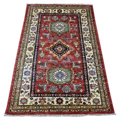 Tappeto Afghano Super Kazak in lana rosso rubino con medaglioni geometrici