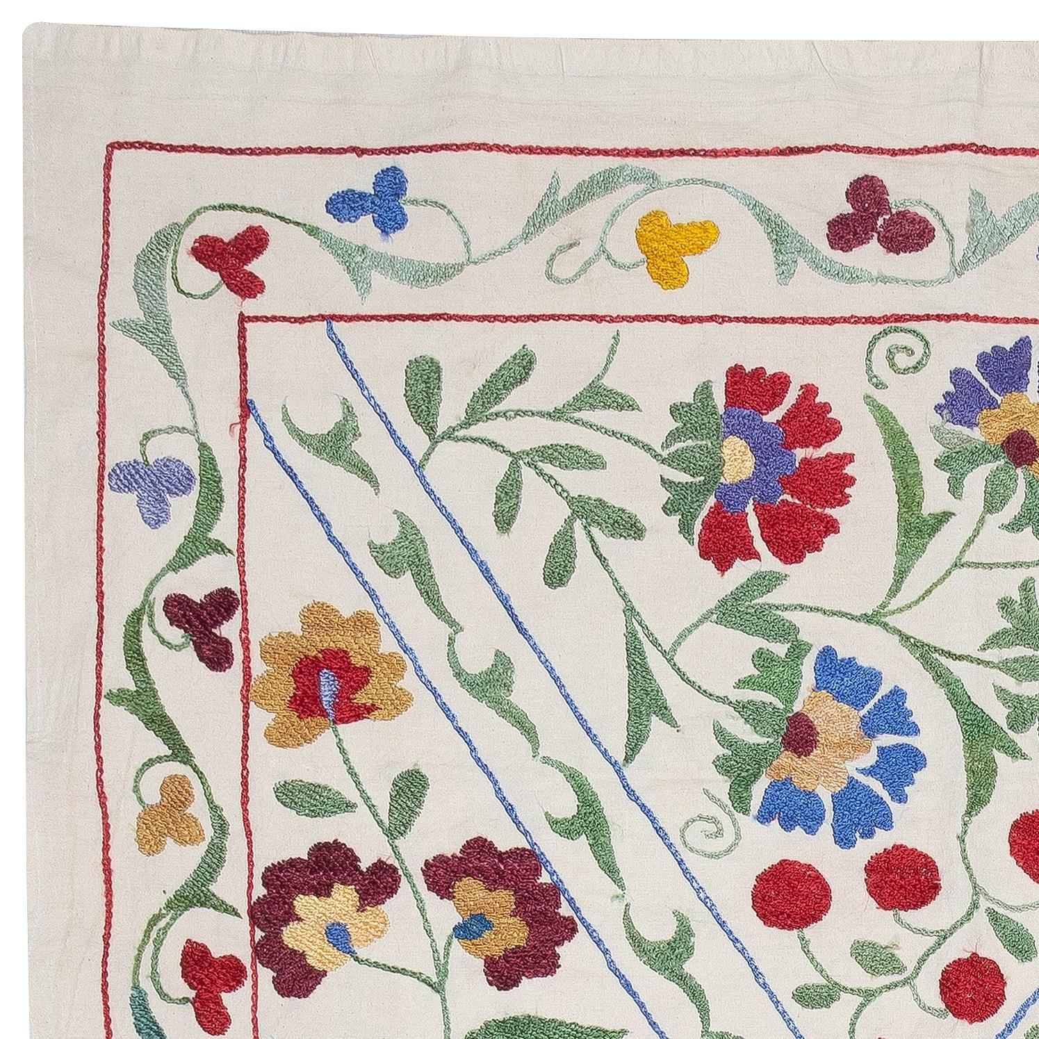Introducing our exquisite new suzani hand embroidered wall hanging, a captivating piece that combines ancient craftsmanship with modern artistry. This embroidered cloth is not just a suzani throw, but a remarkable suzani wall hanging that will