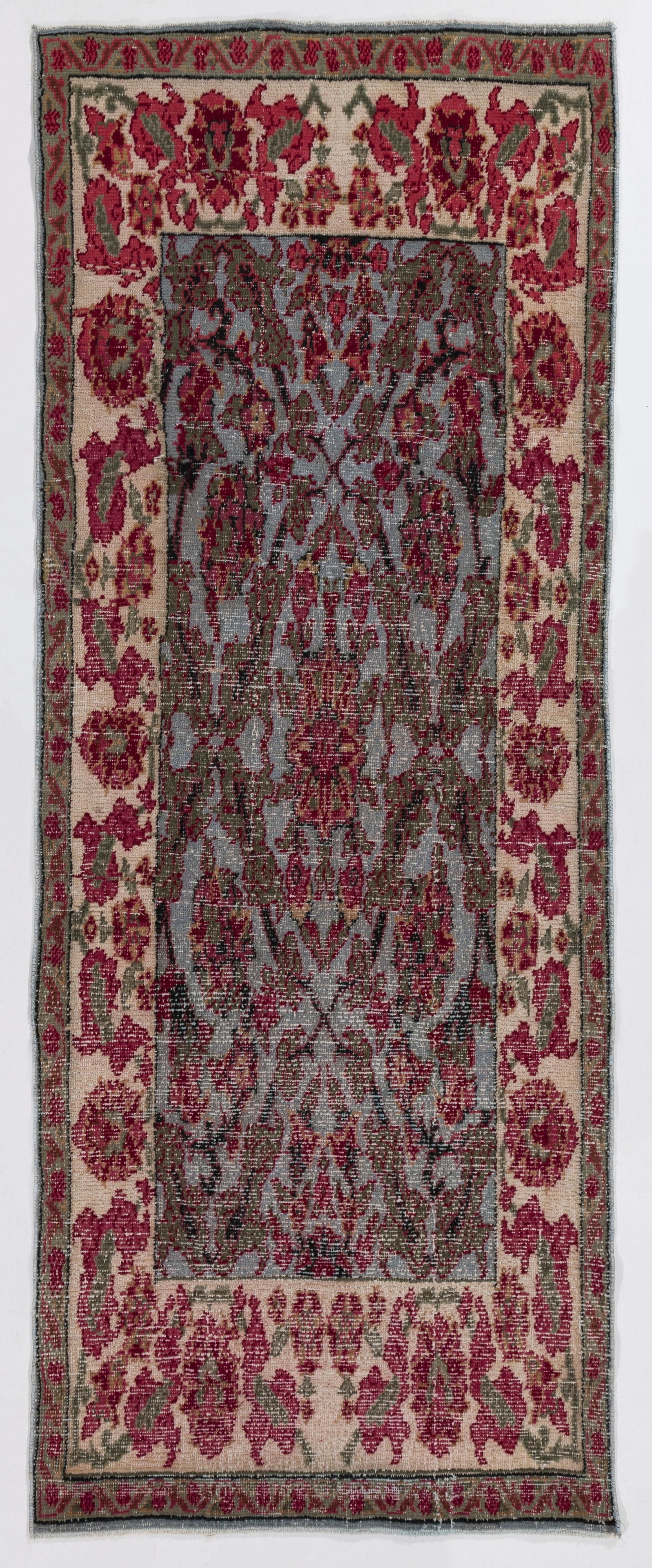 A finely hand knotted vintage Central Anatolian rug with a Classic garden design with flowers, spandrels, blossoms, leaves and branches with pleasant colors. Measures: 3.3 x 8.2 Ft

Wool pile on a tightly woven cotton foundation, very good