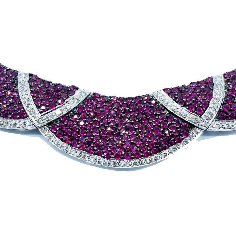 Ruby Necklace Collar with Diamonds set in 18 karat white gold. 
Gorgeous necklace is designed with crescent shapes of rubies accented by diamonds. The widest front of necklace is 18.70mm and graduates to back of 7mm. Clasp is hidden with special
