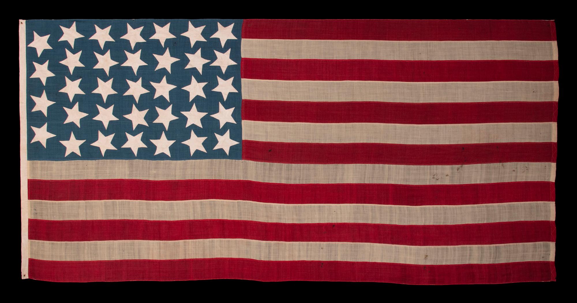 Antique civil war flag with 34 large stars, oriented in all directions, on a rich, steel blue canton, reflects Kansas statehood, 1861-1863

34 star American national flag with a number of visually attractive features. Chief among these are its