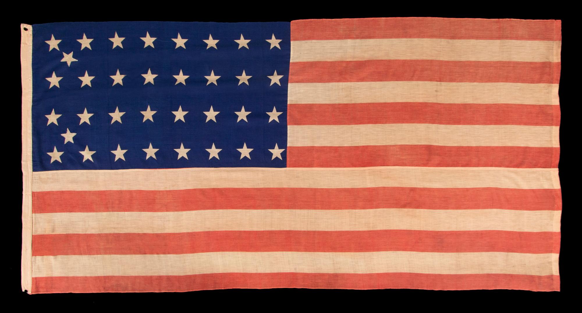 34 STAR ANTIQUE AMERICAN FLAG OF THE CIVIL WAR PERIOD (1861-63), WITH WOVEN STRIPES, PRESS-DYED STARS, AND BEAUTIFUL COLORS, POSSIBLY MADE IN NEW YORK BY THE ANNIN COMPANY, REFLECTS THE ADDITION OF KANSAS TO THE UNION, 1861-1863

34 star flag of the
