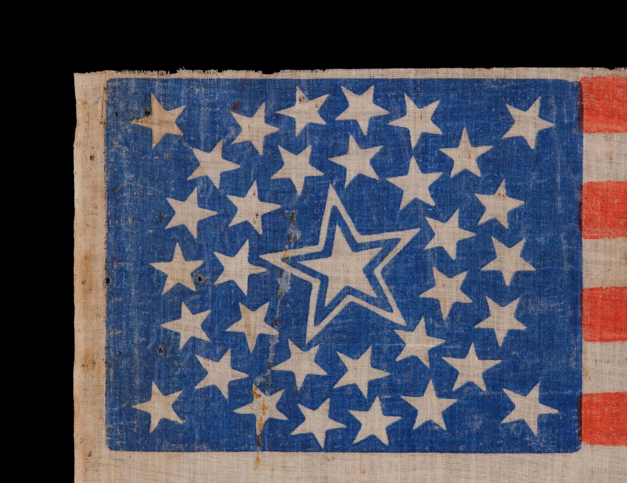 34 STARS IN A MEDALLION CONFIGURATION ON AN ANTIQUE AMERICAN PARADE FLAG WITH A LARGE, HALOED CENTER STAR; CIVIL WAR PERIOD, KANSAS STATEHOOD, 1861-1863

34 star American national parade flag, printed on cotton and bearing a beautiful medallion