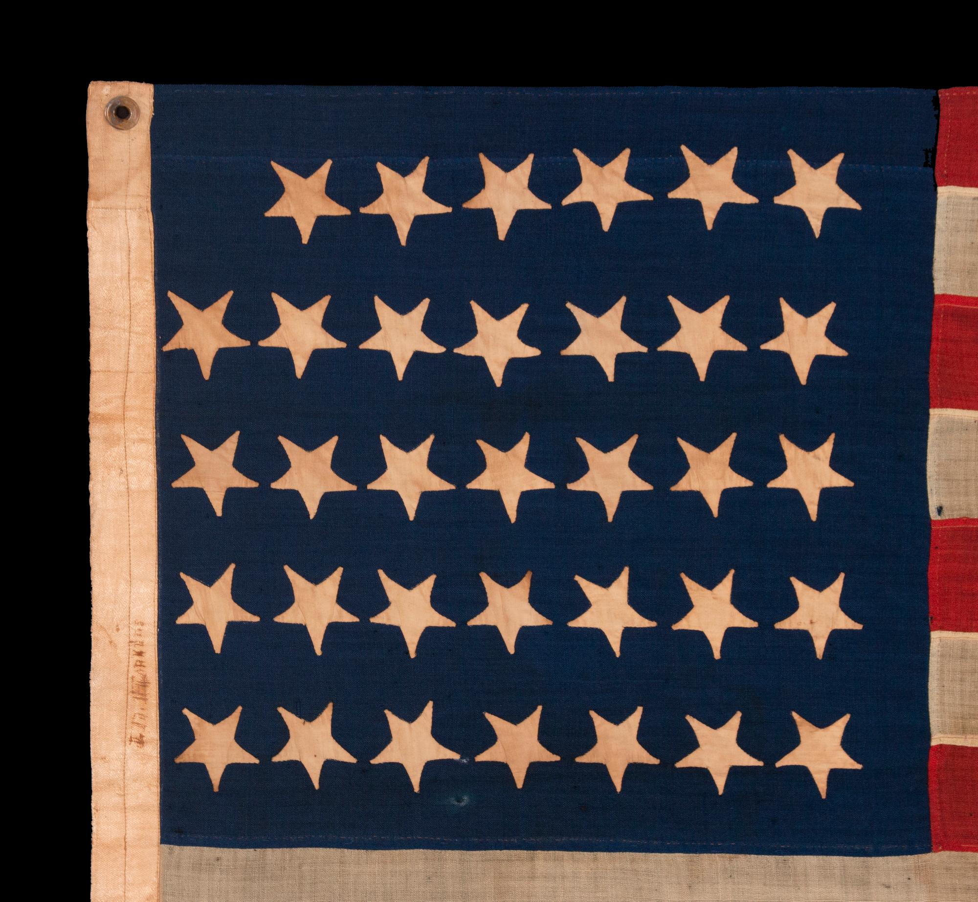 34 Upside-down, Hand-sewn Stars In A Notched Configuration, On An Antique American Flag Of The Civil War Period, With A Beautiful And Highly Unusual Jacquard Weave Binding, And In A Tiny Scale Among Its Counterparts, Reflects The Addition Of Kansas