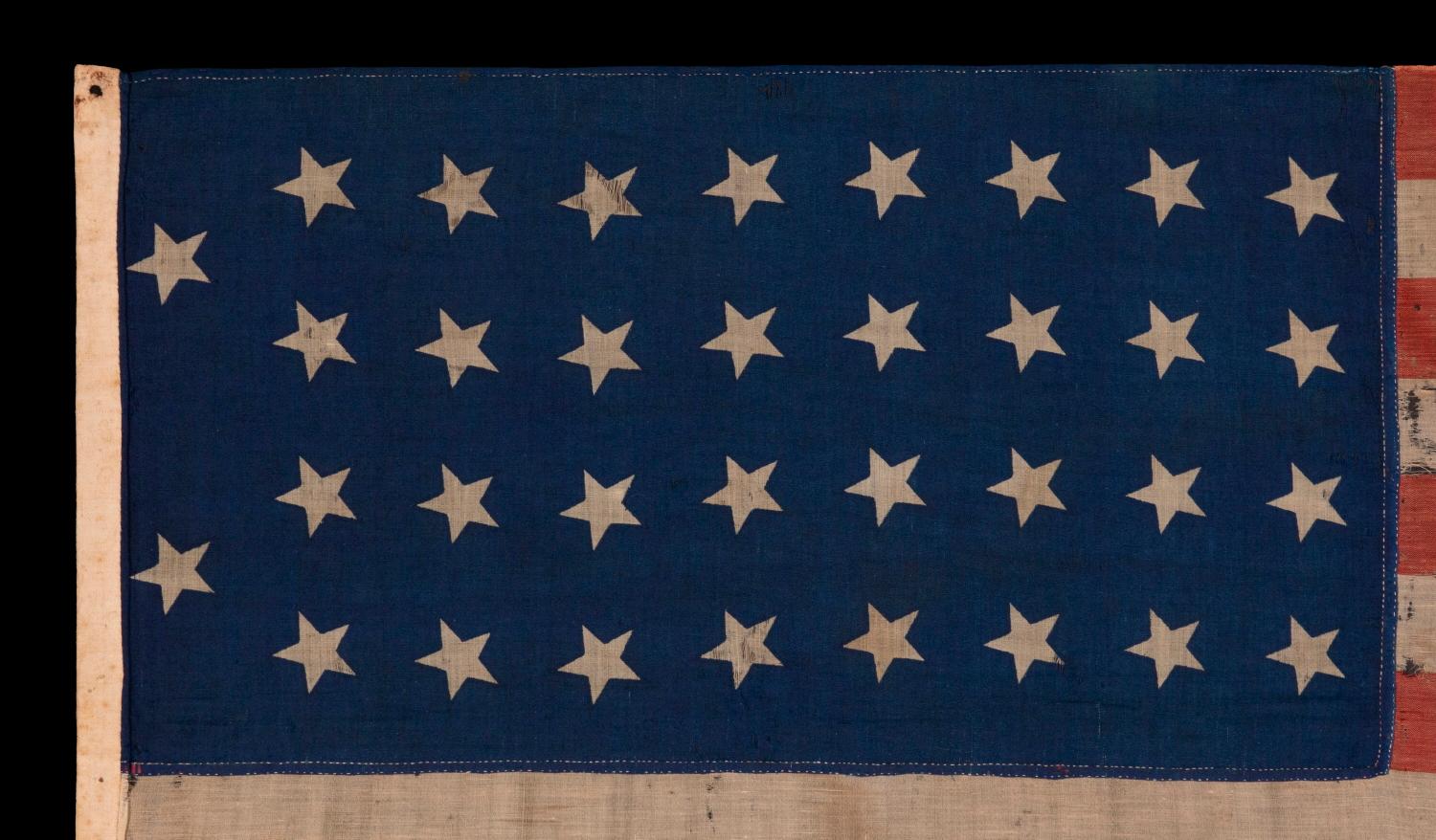 34 STARS IN 4 ROWS WITH 2 STARS OFFSET AT THE HOIST END, LIKELY A UNION ARMY CAMP COLORS, ONE OF ONLY THREE EXAMPLES I HAVE ENCOUNTERED IN THIS EXACT STYLE, OPENING TWO YEARS OF THE CIVIL WAR, 1861-1863, REFLECTS THE PERIOD WHEN KANSAS WAS THE MOST