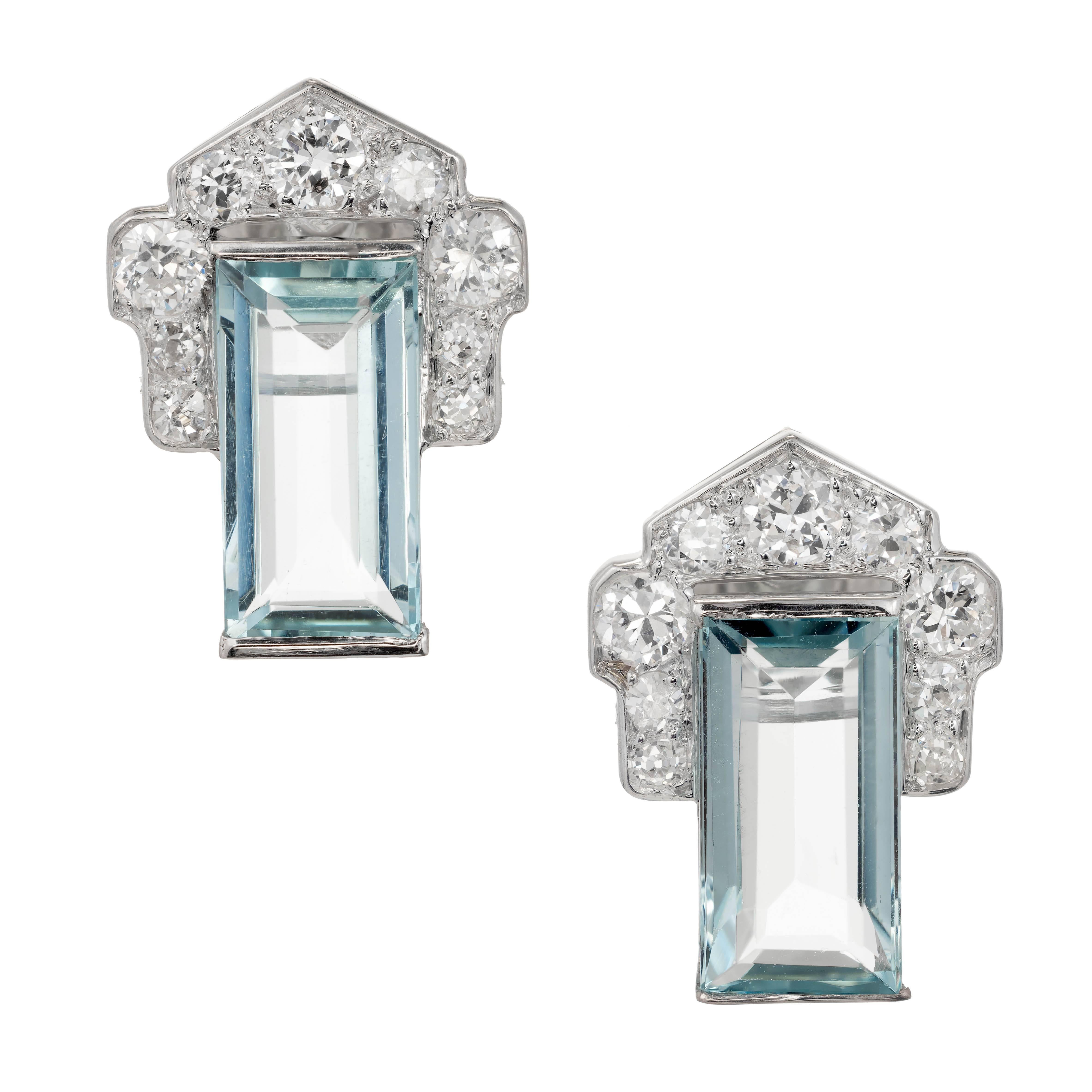 Art Deco Aquamarine and diamond cluster earrings. Rectangular step cut aquamarine encased on the top half by a flared diamond cluster. Group of varying sizes of pave set round diamonds in platinum. earrings

2 emerald cut aquamarine 10.80 x 5.64 x