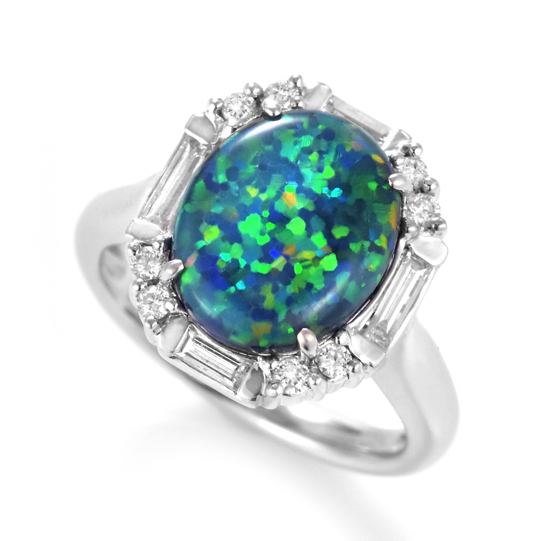 A beautiful ring featuring a 3.40 Carat Australian Black Opal and 0.50 Carat Diamonds made in Platinum. The Opal displays very good play of color! Opals are known for exhibiting flashes of rainbow colors known as 