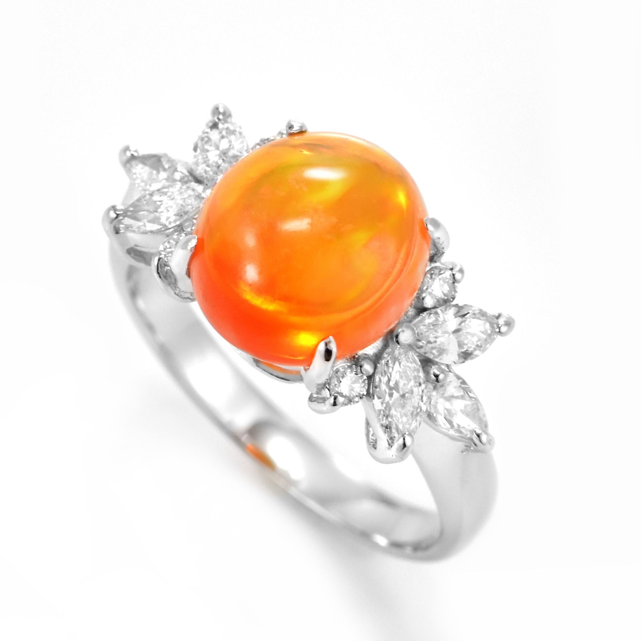 A beautiful ring featuring a 3.40 Carat Natural Fire Opal and 0.56 Carats of Diamond Accents set in Platinum. Opals are known for exhibiting flashes of rainbow colors known as 
