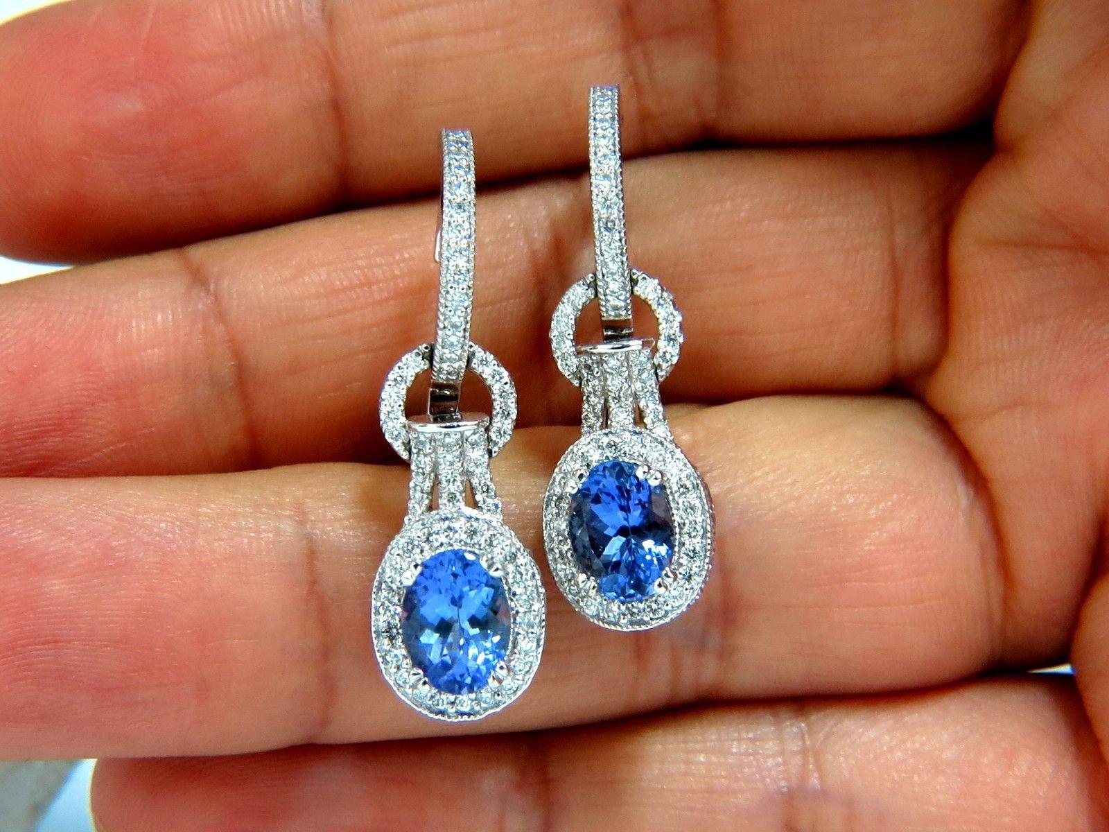 Tanzanite Dangle.

2.14ct natural oval tanzanites

Clean Clarity & Transparent

8 X 6mm each

1.26ct. Natural diamonds  

Rounds, Full cut brilliants.

G- color Vs-2 Clarity. 

Comfortable hoops, and secure snap

Excellent detail.

14kt. white