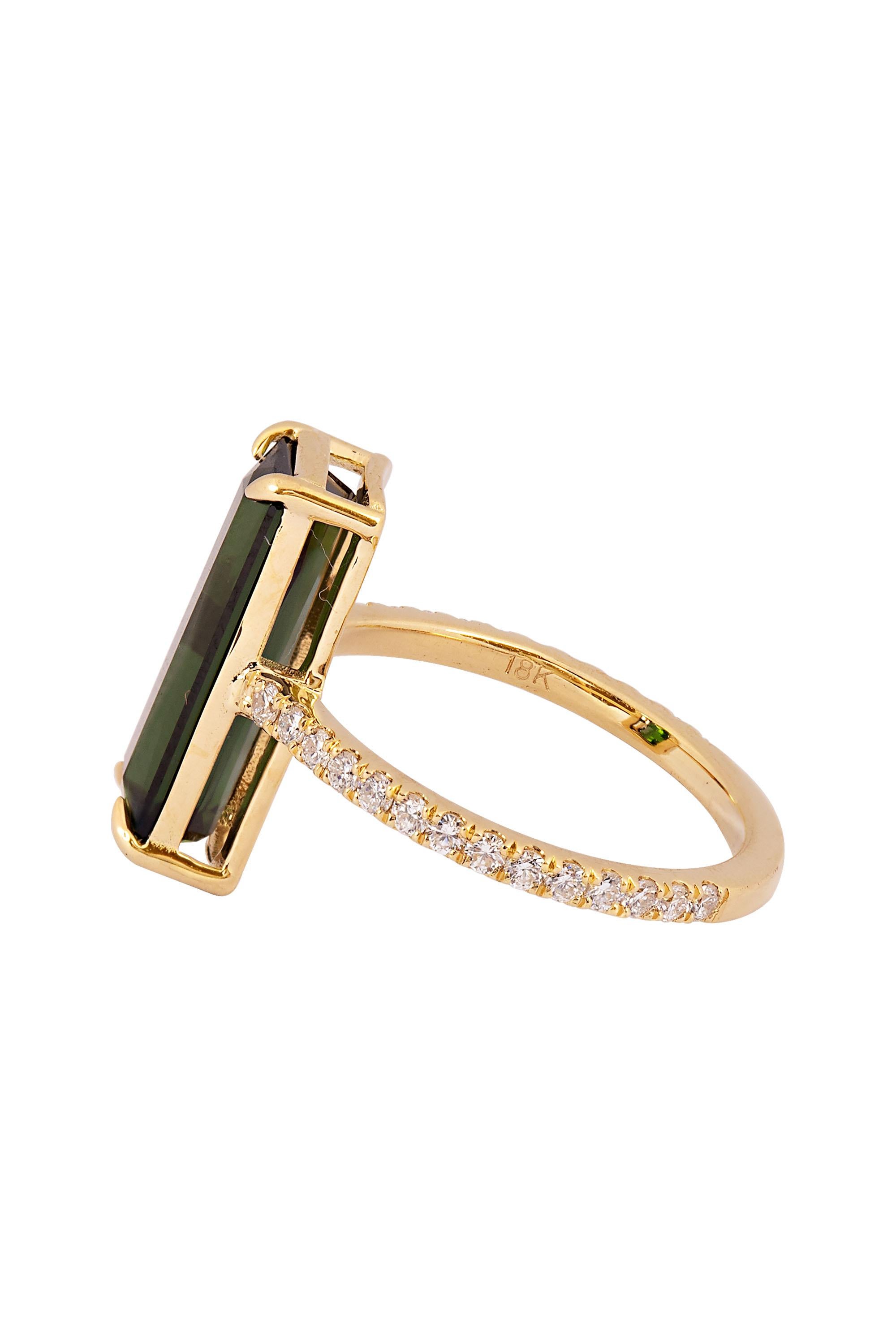 This stylish ring is composed of an elegant rectangle of rich green tourmaline mounted atop a streamlined ring of 18 karat yellow gold highlighted by pave diamond shoulders. With an approximate total diamond weight of .75 carats. Current ring size