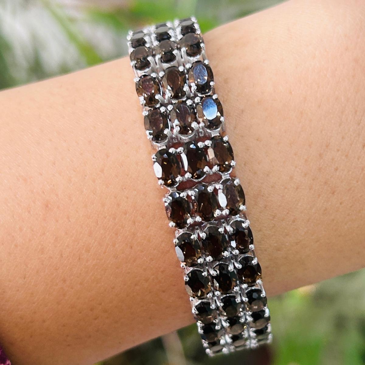 34.03 Carat Smoky Topaz Three Layer Wide Bracelet in sterling silver showcases endlessly sparkling natural smoky topaz, weighing 34.03 carat. It measures 7.5 inches long in length. 
Smoky Topaz stimulate concentration and reduces stress. 
Designed