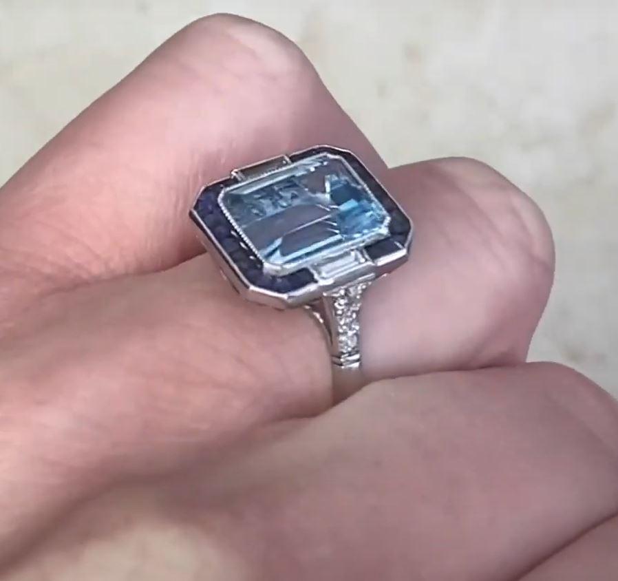 This exquisite platinum ring showcases a breathtaking elongated emerald-cut aquamarine, weighing approximately 3.4-carats. The natural aquamarine exhibits a mesmerizing icy-blue hue, its clarity and brilliance enhanced by expert faceting. A