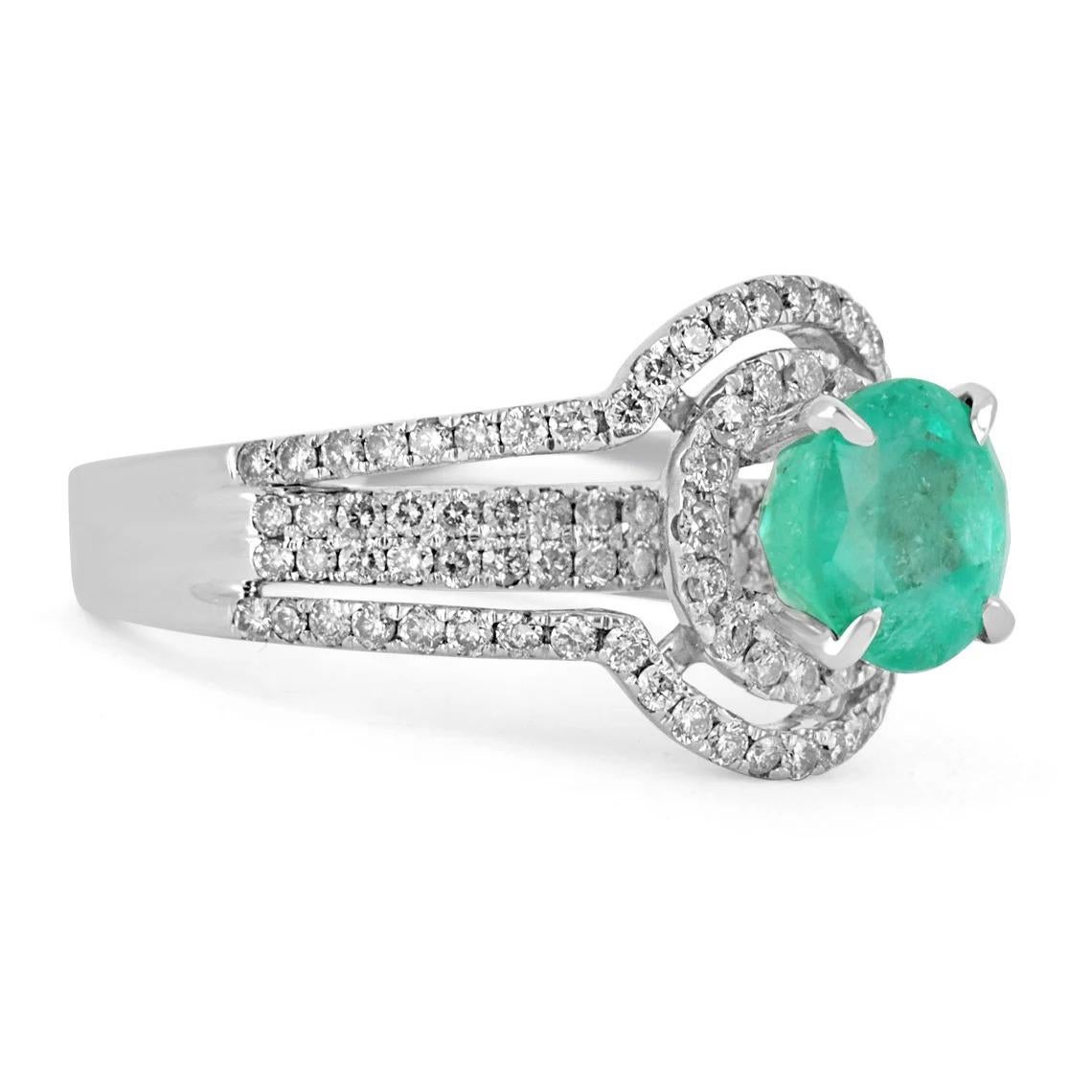 Be prepared to receive many compliments on this beauty! This is a magnificent 1.34tcw natural Colombian emerald and diamond split shank engagement ring. This is a perfect statement ring with a gorgeous center stone. The center gemstone is a fine