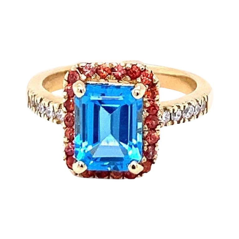 3,41 Karat Blauer Topas Saphir Diamant Gelbgold Verlobungsring

Dieser Ring hat eine herrliche Emerald Cut Blue Topaz, dass 2,80 Karat wiegt und ist umgeben von 22 Round Cut Orange Sapphires, dass 0,41 Karat wiegen und 10 Round Cut Diamanten entlang