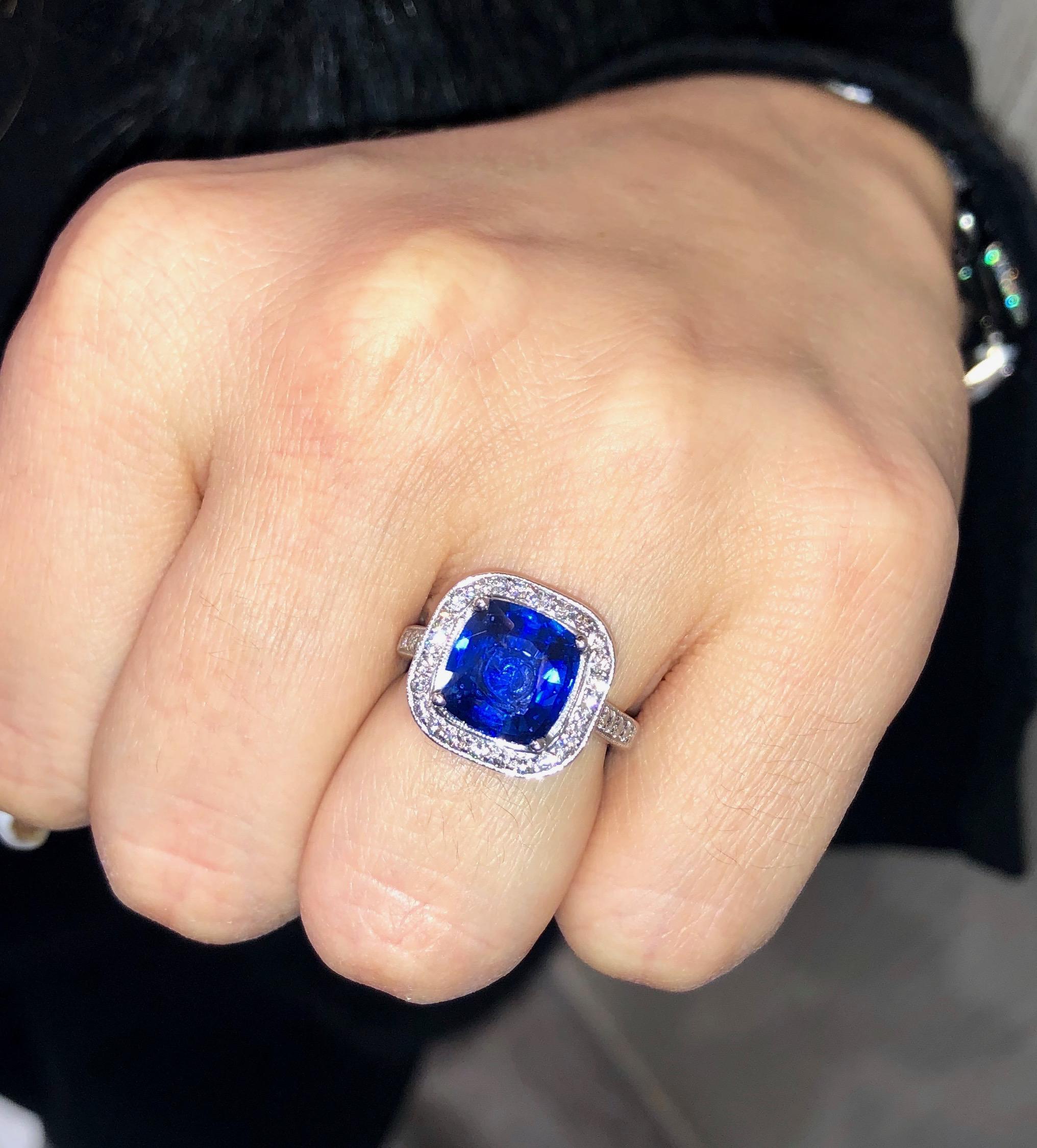    Gorgeous diamond and cushion cut sapphire classic center stone ring with Diamond Halo 
The center contains a 3.41 carat Royal Blue cushion shape sapphire.
The natural sapphire is mounted in a platinum setting surrounded by brilliant cut white