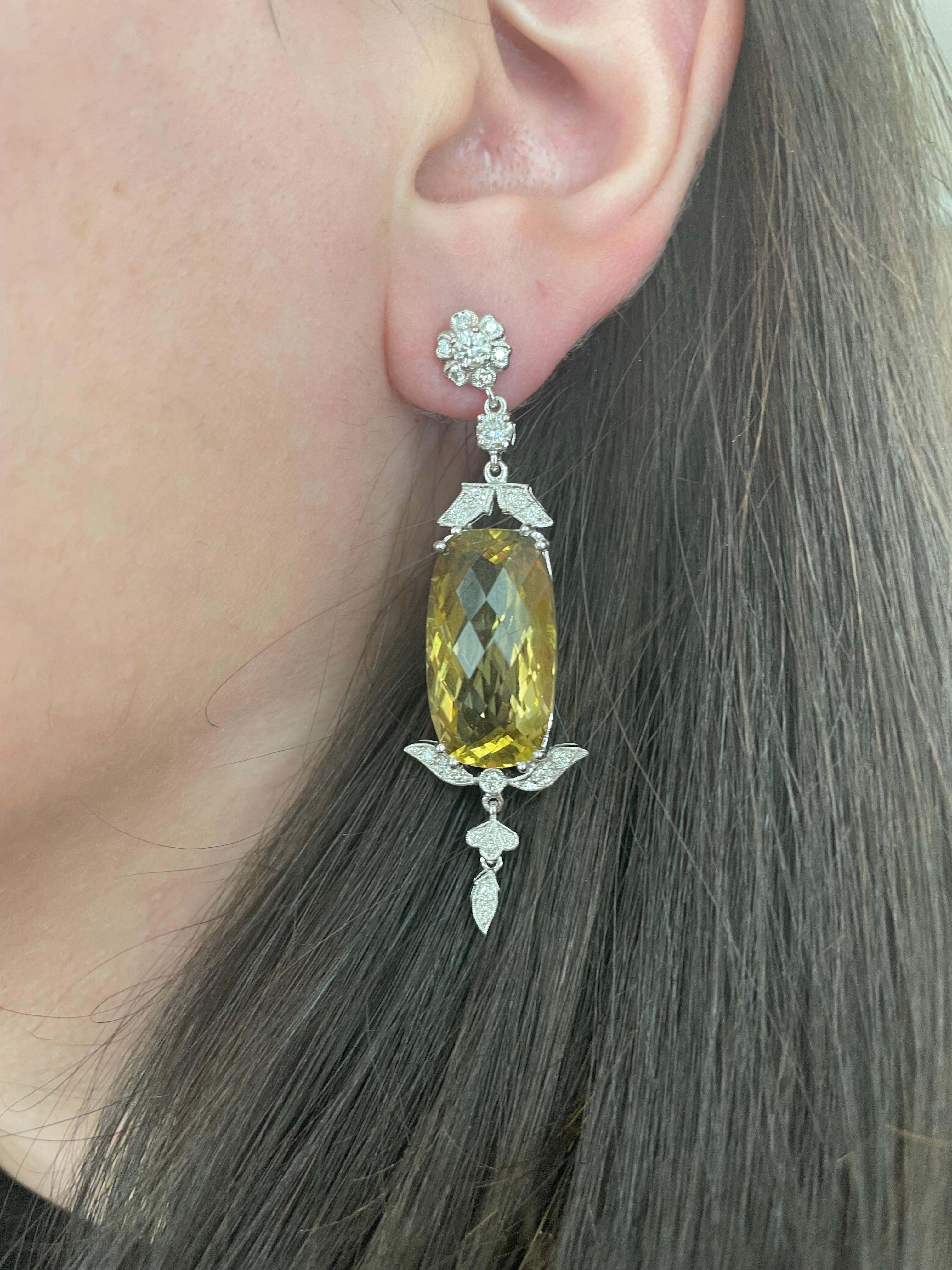 Lovely large lemon with diamond earrings.
2 lemon quartz, 34.18 carats total. Complimented by 44 round brilliant diamonds, 1.24 carats. Approximately H/I color and SI clarity. 18-karat white gold.
35.42 carats total gemstone weight.
Accommodated