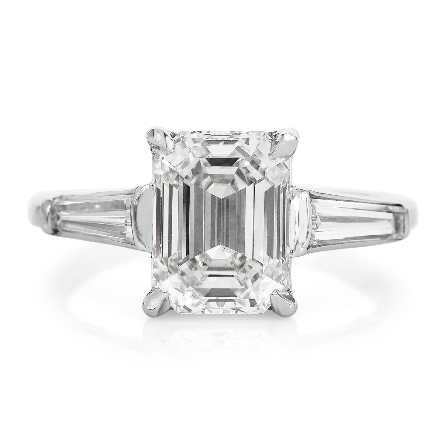 This beautiful classic diamond engagement ring is crafted in solid platinum.

Showcasing a classic design, it is centered with one genuine emerald- Cut Diamond,

3.06, J color, VS1 clarity, GIA Graded,  prong set. The center stone is accented with 2
