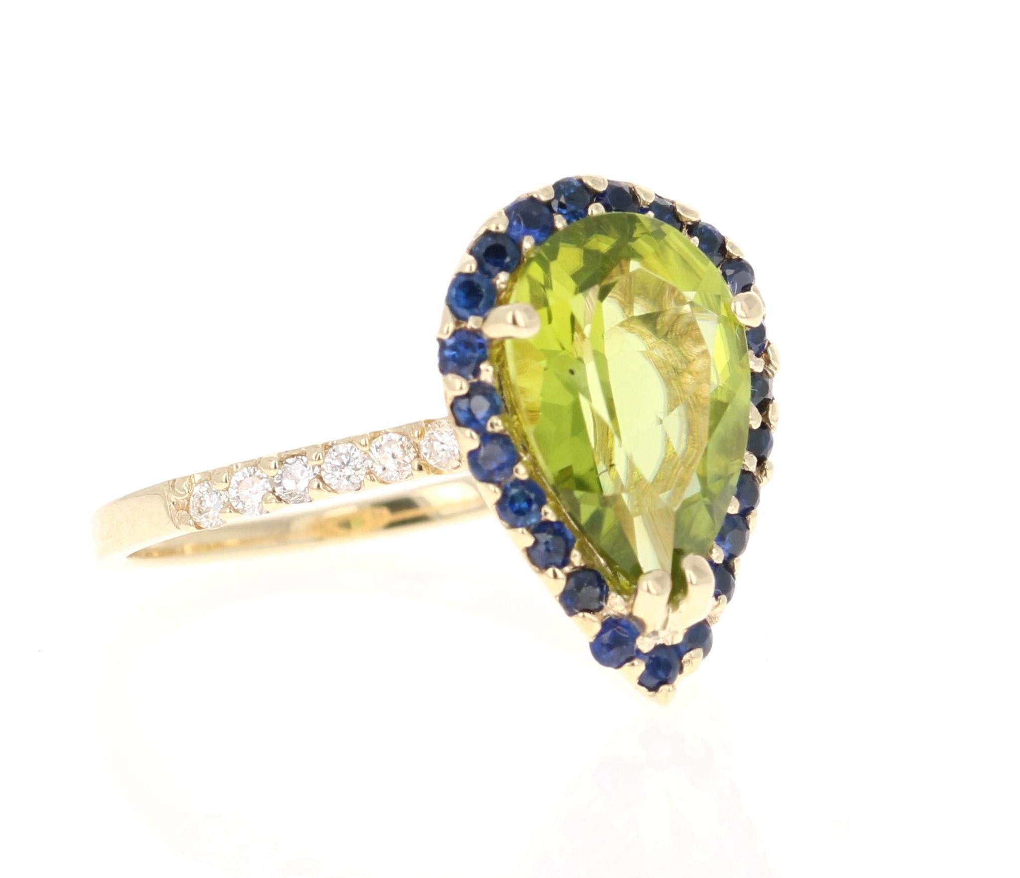 This beautiful ring has a Pear Cut Peridot in the center that weighs 2.80 carats. The ring is surrounded by a cute halo of blue sapphires. There are 23 Blue Sapphires that weigh 0.45 carats and there are 12 Round Cut Diamonds that weigh 0.17 carats