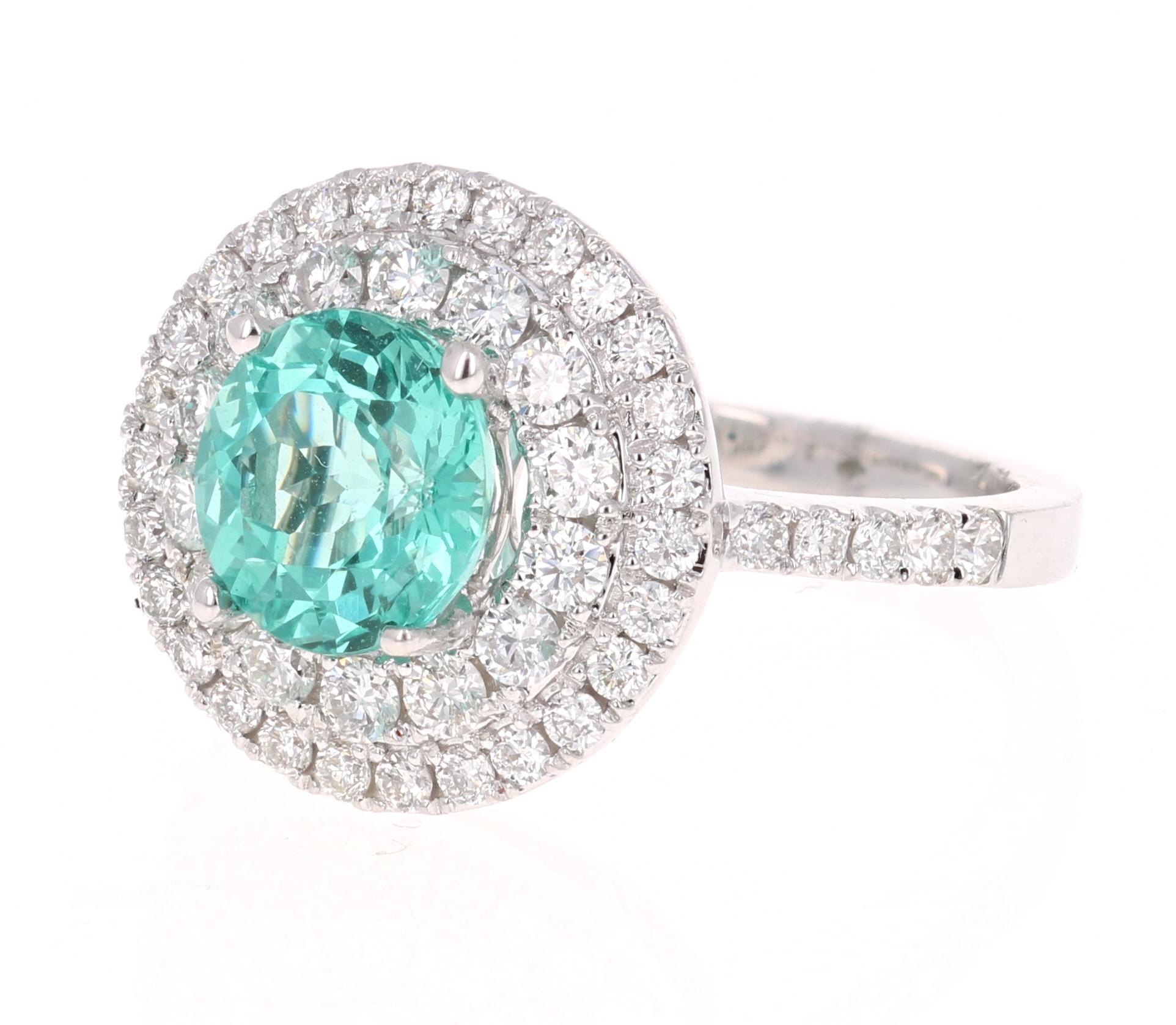 Gorgeous Double Halo Apatite and Diamond Ring.  This ring has a Round Cut 2.44 carat Apatite in the center of the ring and is surrounded by a double halo of 56 Round Cut Diamonds that weigh 0.98 carat (Clarity: SI2, Color:F).  The total carat weight
