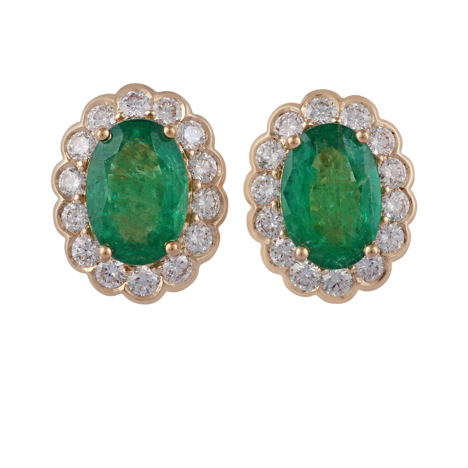 An exclusive pair of earrings with oval-shaped emerald 3.43 carat surrounded by the cluster of diamonds features 28 brilliant-cut round diamonds 1.18 carat the entire earring is studded in 18 karat yellow gold weight 6.47 grams, these earrings have
