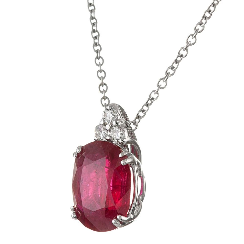 Elegant simplicity is offered by this classically styled diamond solitaire pendant. The ruby weighs 3.43 carats and is suspended from a triangular bale made of three white diamonds. The piece is accompanied by an IGI appraisal report and mounted in