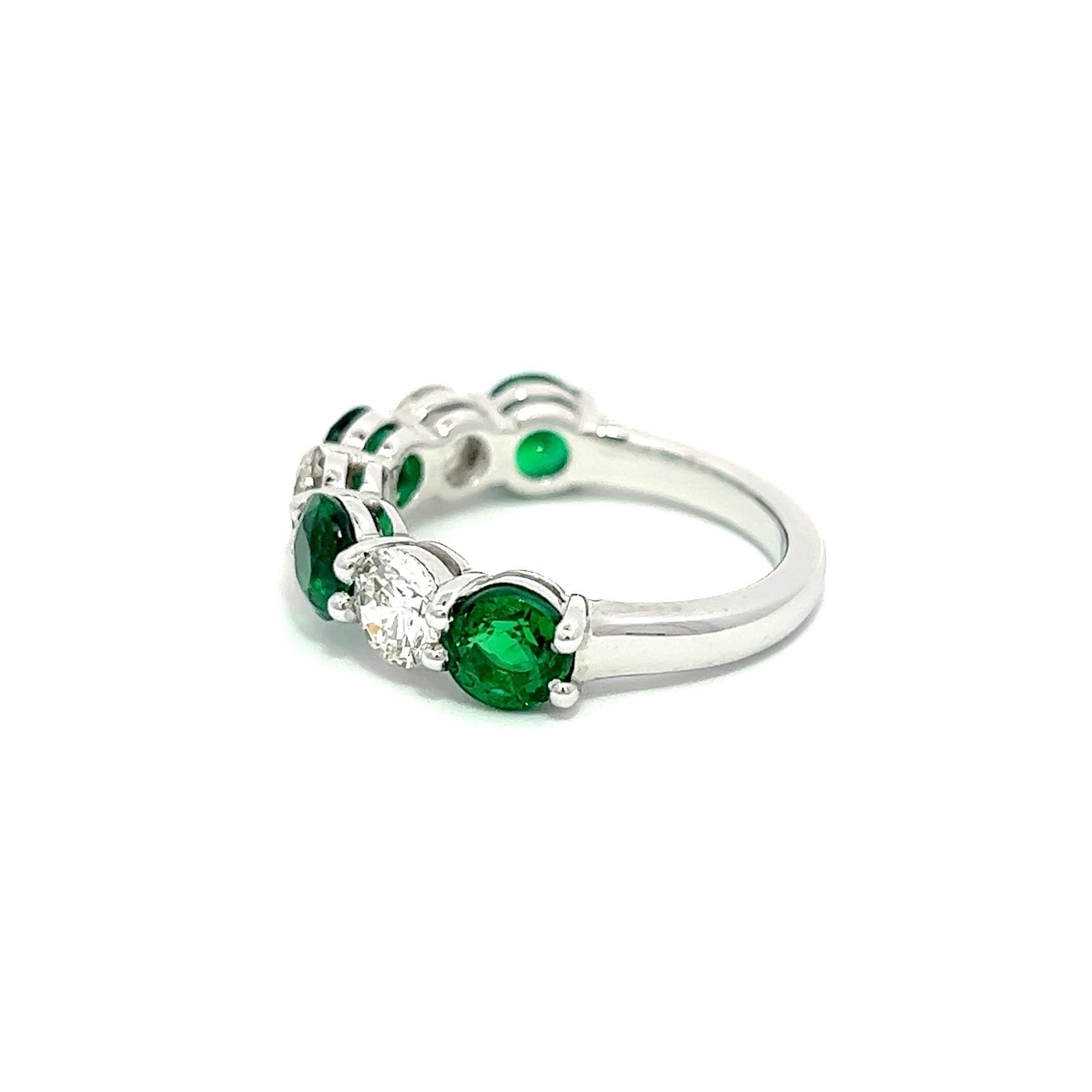 This ultimate classic eternity ring symbolizes eternal love - a promise of a lifelong commitment. Round diamonds & Zambian  Natural Emeralds with a platinum setting. A gallery is created as the diamonds & Emeralds are slightly elevated, featuring a