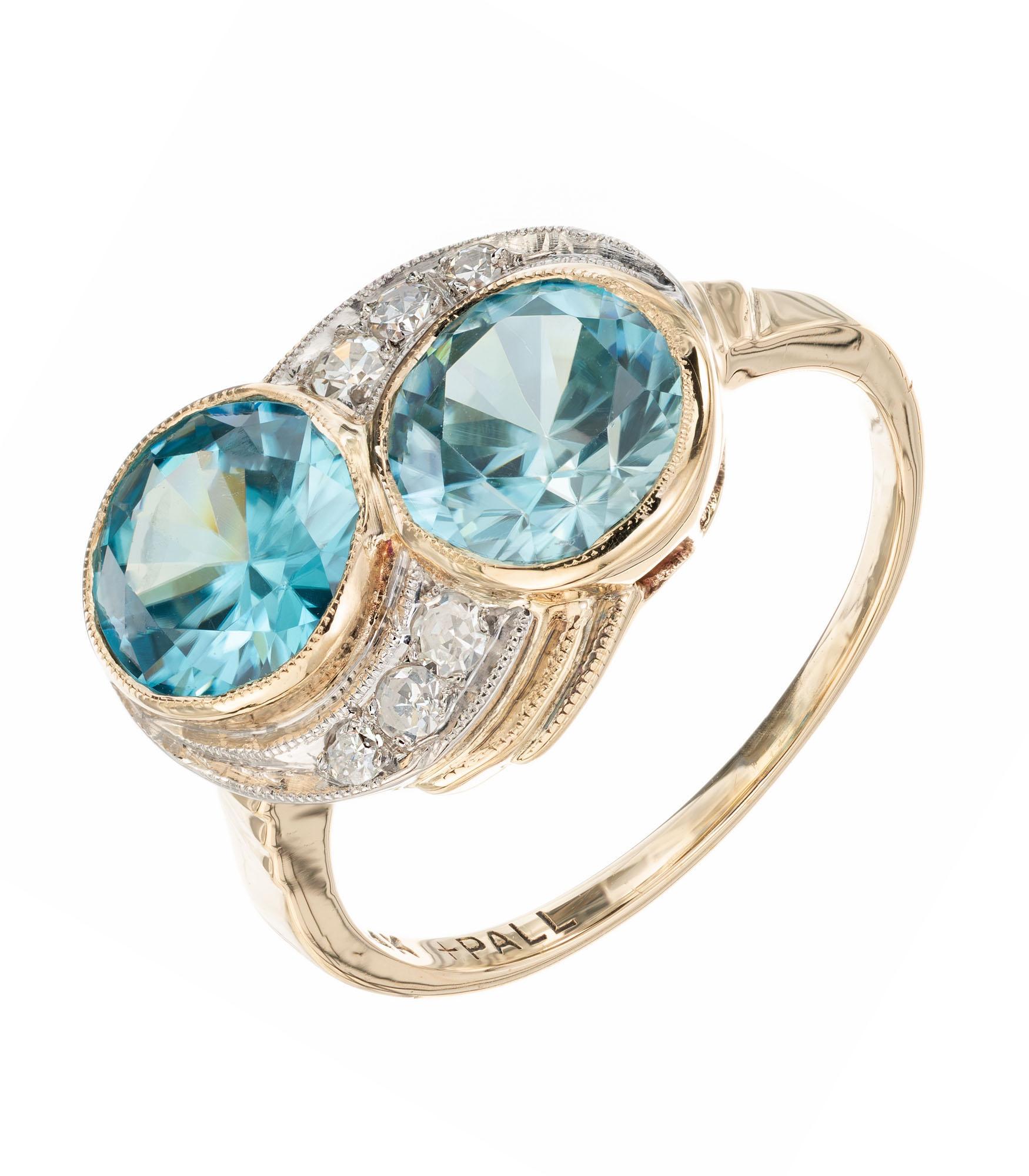Zircon and diamond engagement ring. 2 round blue zircons set in 14k yellow gold with 6 single cut accent diamonds set in pallidum. Circa 1940's.

2 round greenish blue zircon, VS approx. 3.44cts
6 single cut diamonds, H-I SI approx. .8cts
Size 5.5