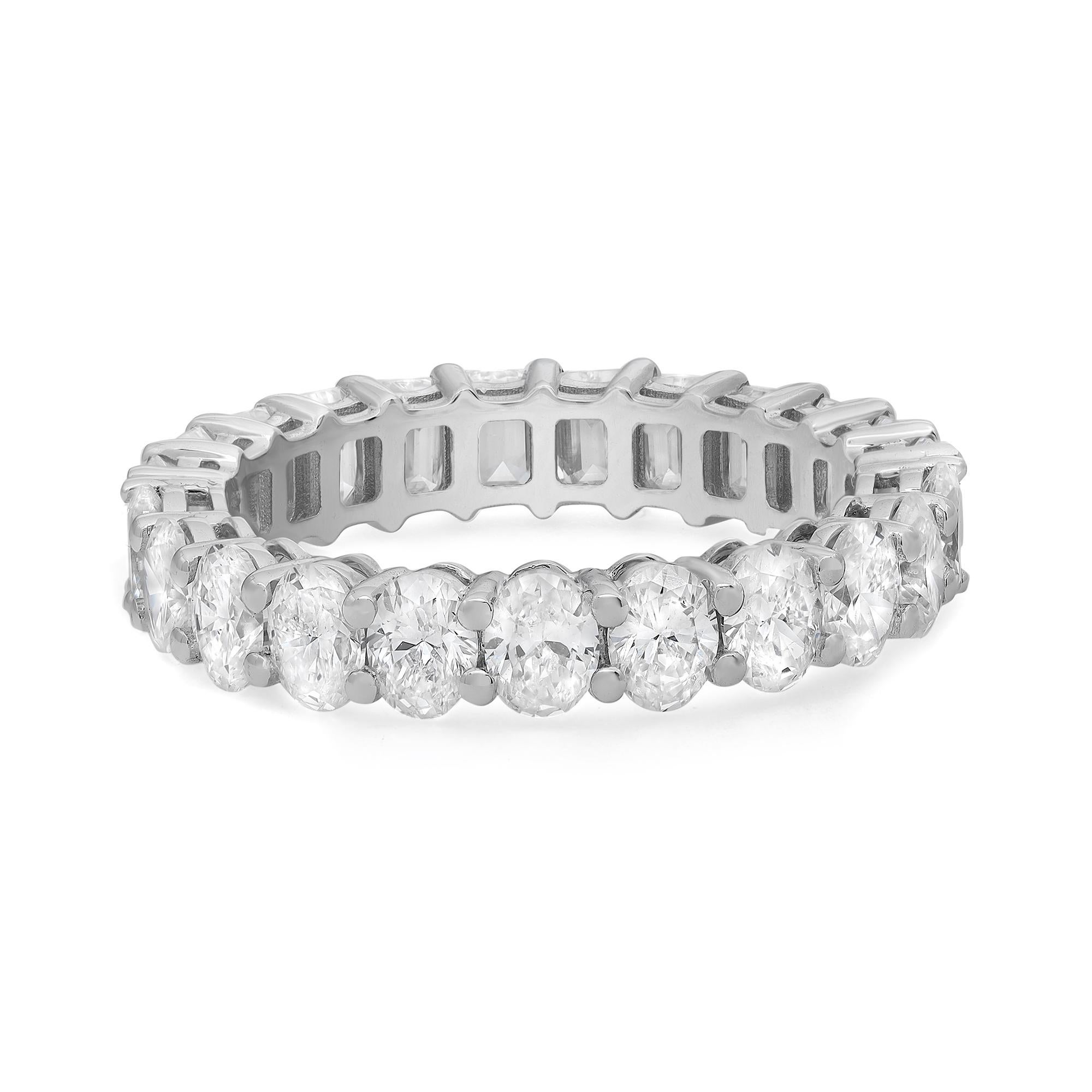 Show off your trendsetting style with this unique diamond eternity band ring. Crafted in 18k white gold and encrusted halfway with Oval shaped diamonds and another half with Emerald cut diamonds in four prong setting. This ring is a perfect standout