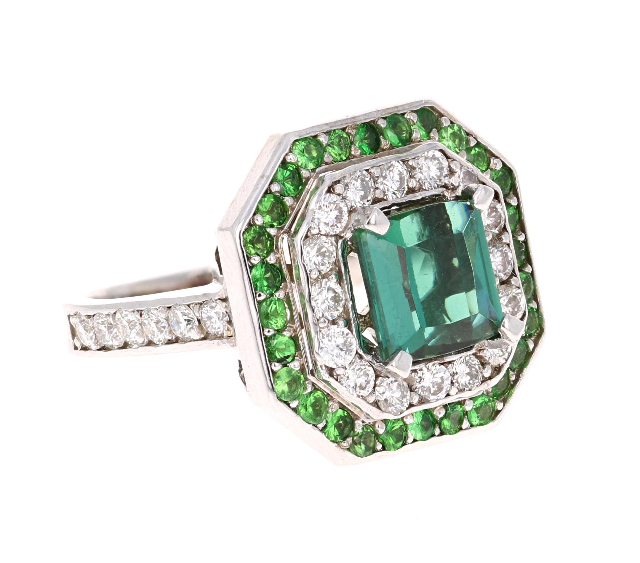 A beauty that is sure to be nothing less than a statement! 

This ring has a magnificently beautiful Emerald Cut Green Tourmaline that weighs 1.97 Carats and has 28 Round Cut Diamonds weighing 0.90 Carats with a clarity and color of SI-F. It is