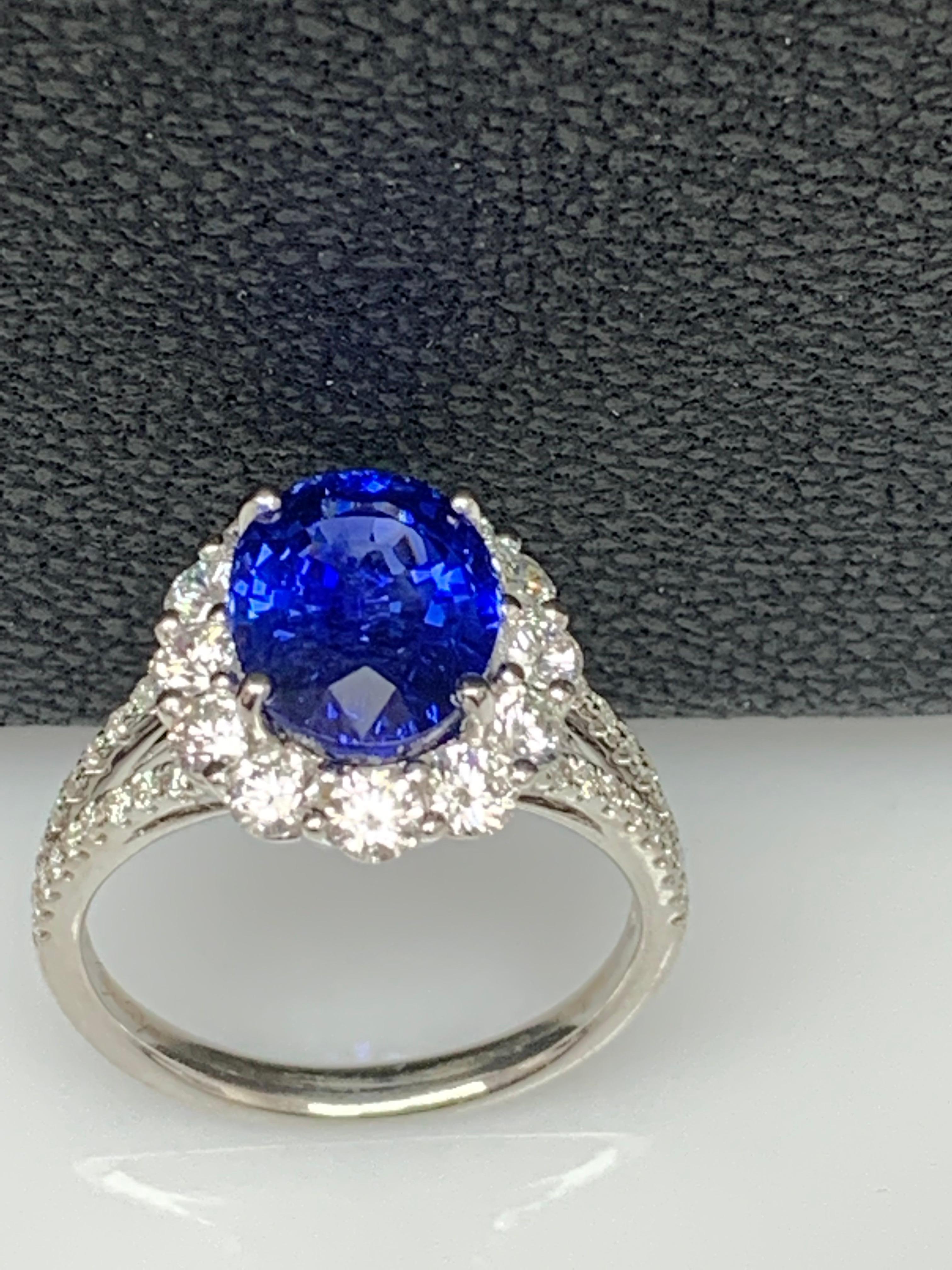 Features a beautiful 3.45-carat oval shape blue sapphire at the center. Surrounded by 12 brilliant-cut round diamonds weighing 0.98 carats in total. Diamonds are also set halfway all over the shank of the ring. The weight of the 36 accent diamonds