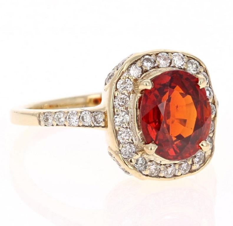 A Spessartine is a natural stone that is a part of the Garnet family of stones. 
This ring has a 2.77 carat Oval Cut Spessartine and is surrounded by 58 Round Cut Diamonds that weigh 0.68 carats. The total carat weight of the ring is 3.45 carats.