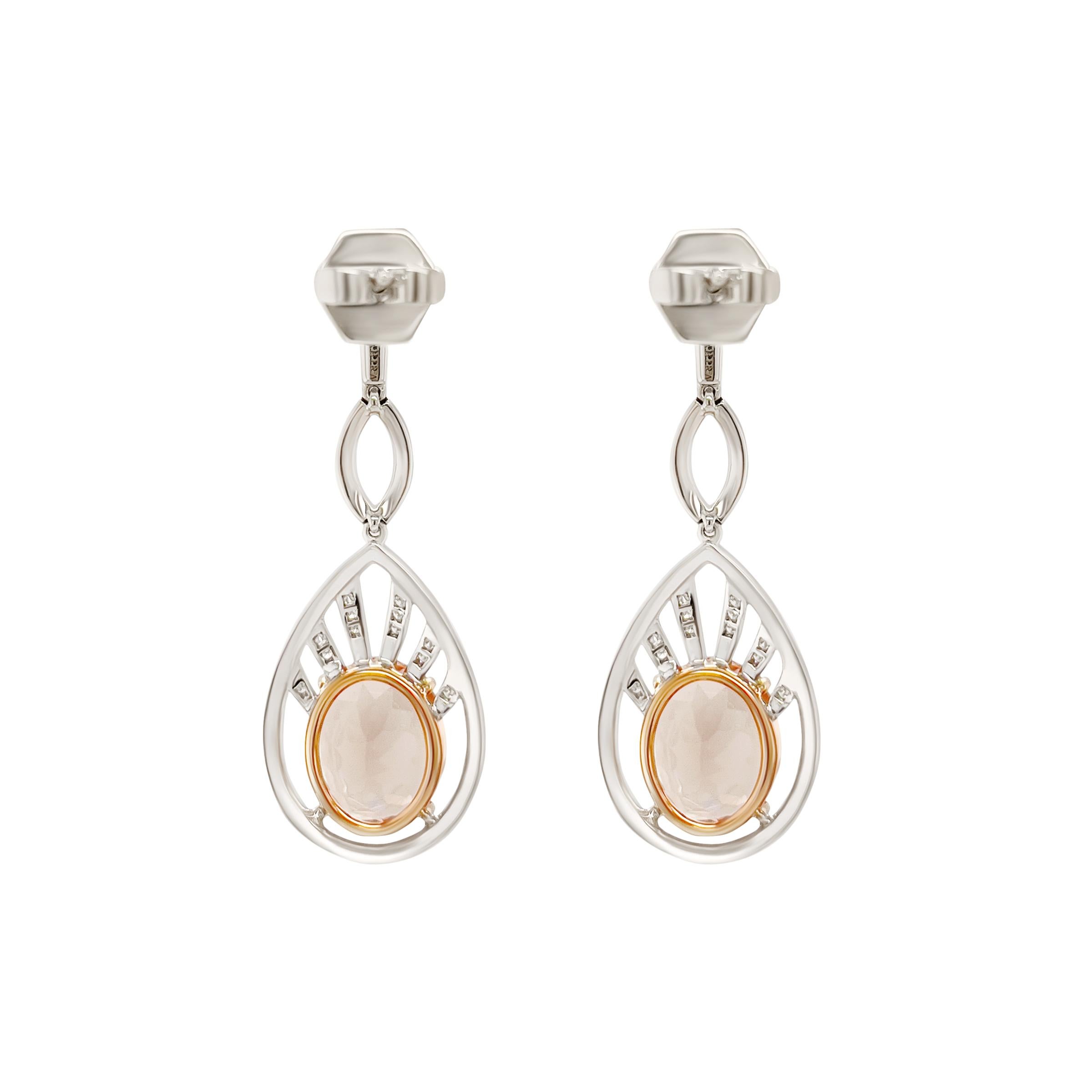 A pair of natural and loupe clean 3.45ct champagne morganites are the center-stones of these dazzling earrings.  Pave'd diamonds surround the morganite totalling .50 cts of G VS diamonds. These earrings were made for movement and is set in 18k white