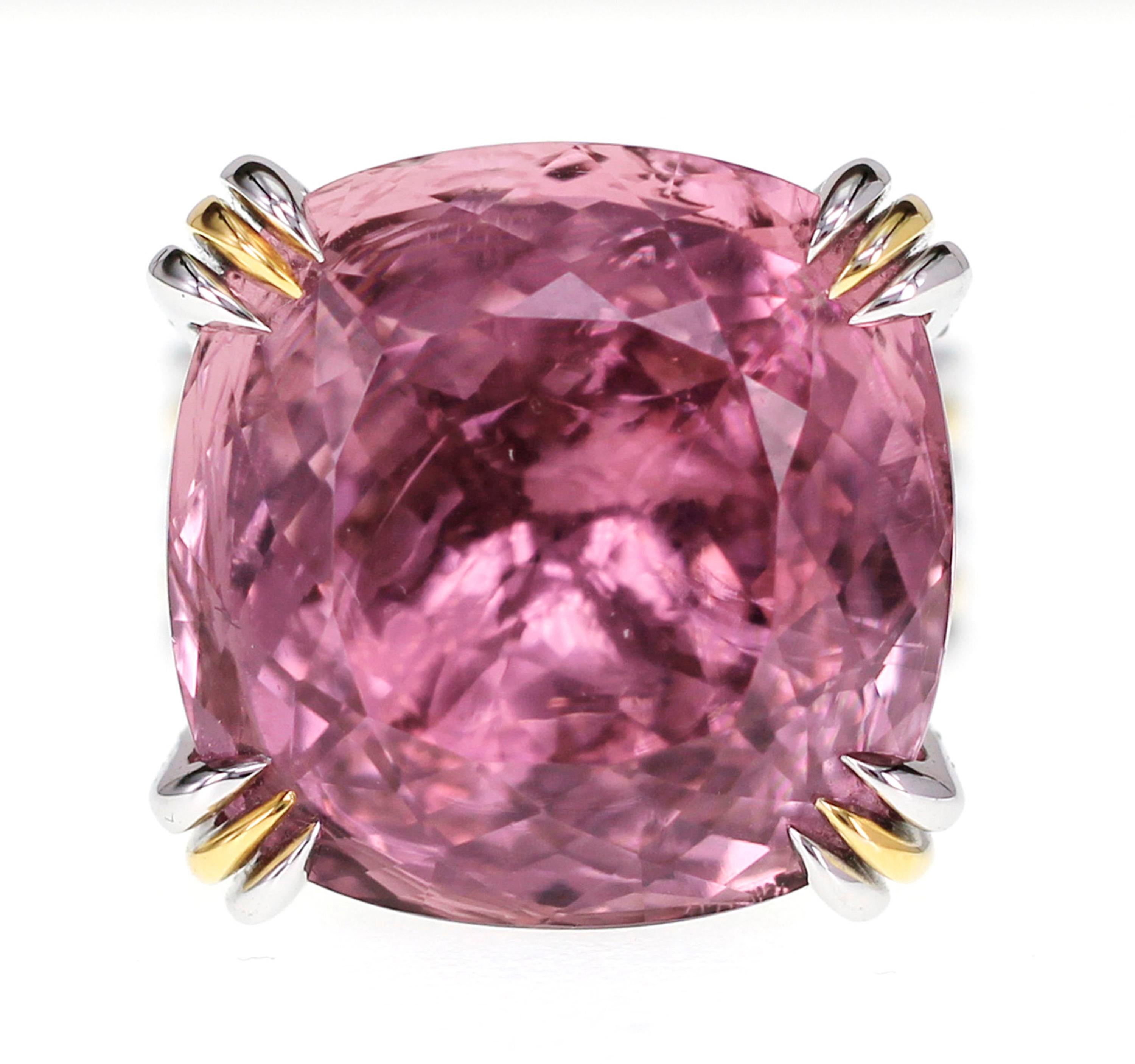 A massive 34.60 carat of Vivid Orangy Pink Rubellite Tourmaline is set with a carat of white brilliant round diamond. The tourmaline was mined in Mozambique and bought to Bangkok for manufacturing. After going through the process, the stone turned