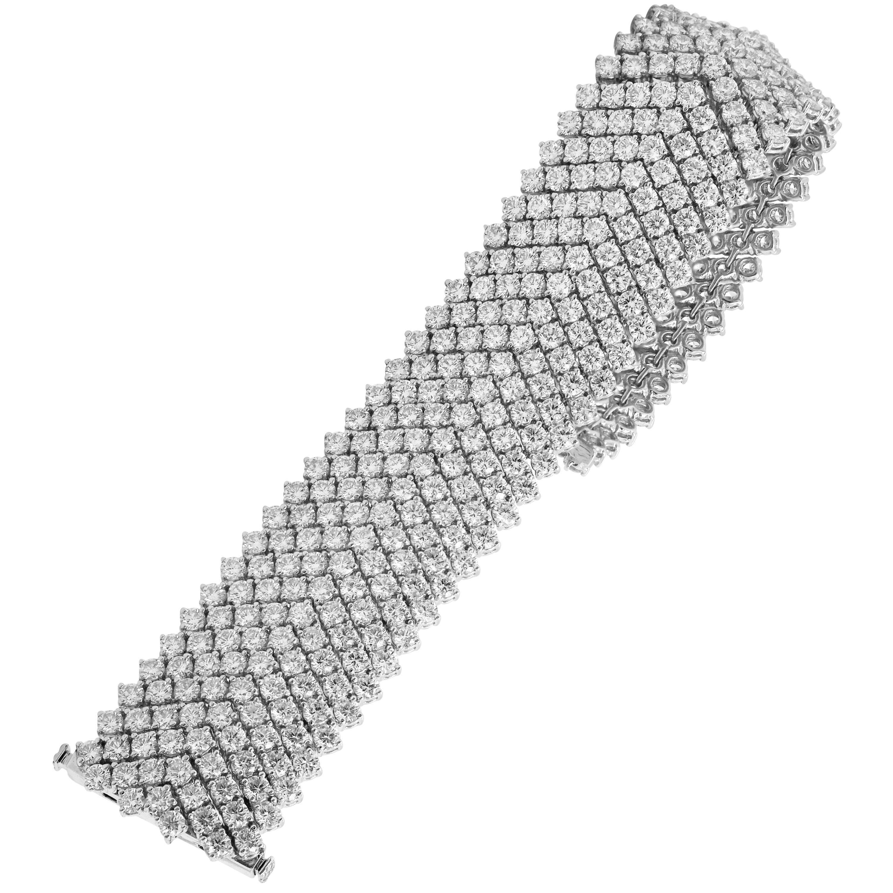 34.63 Carat Diamond 18K White Gold Nine Row Wide Tennis Bracelet

This Nine row tennis bracelet is set entirely with diamonds.

34.63 carat G color, VS clarity diamonds

7 inches in length. 0.86 inch width.

75.20 grams total weight