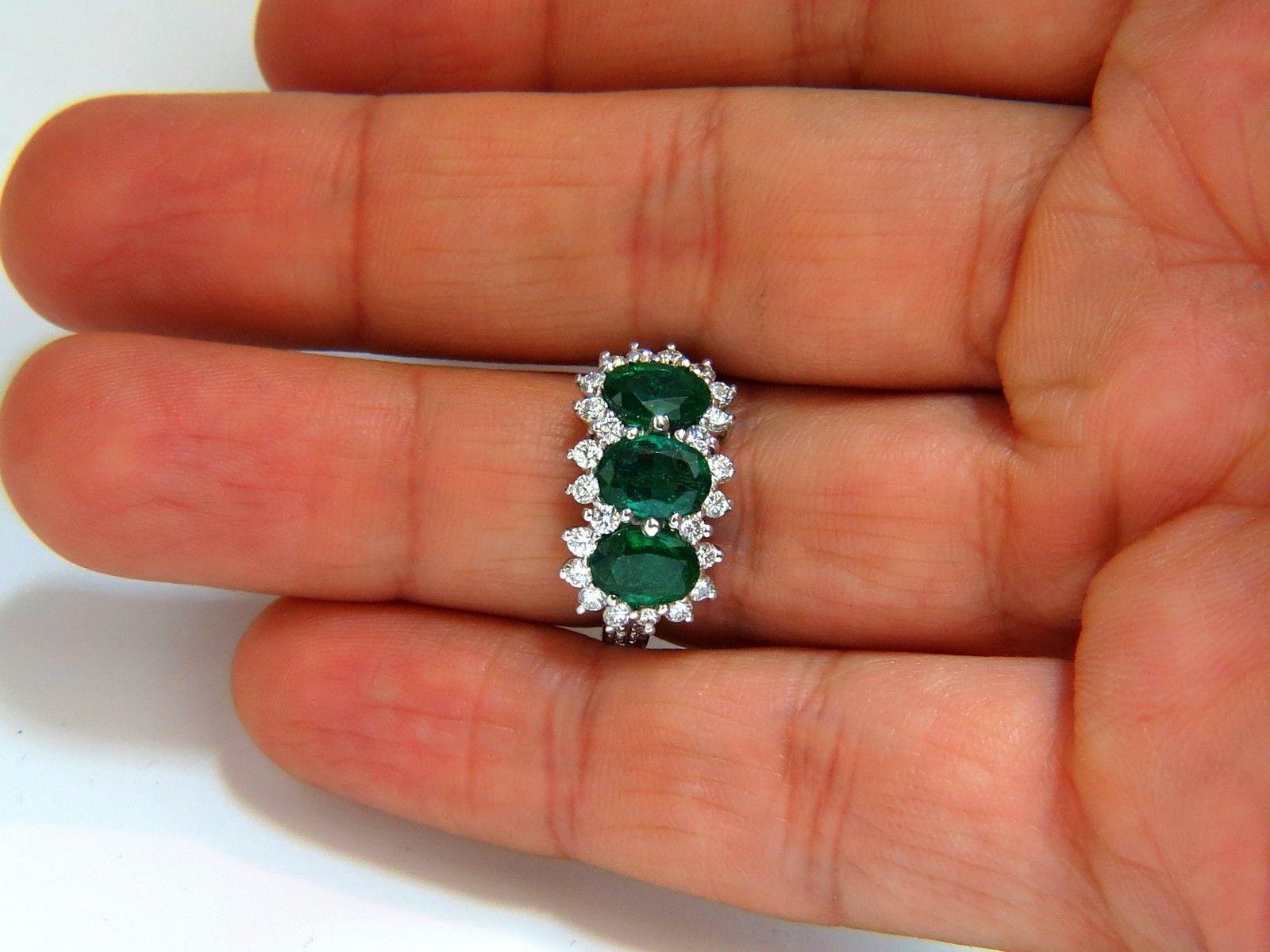 2.46ct. Natural Emeralds diamond ring

Handmade Mount

Center Emerald: 7.5 X 5.2mm

Sides: 7 X 5mm each.

Transparent & Clean clarity.

Vibrant Green tones.

Fully faceted oval cut brilliant

  

Side Round, full cut diamonds:

1.01ct. 

F/G colors,
